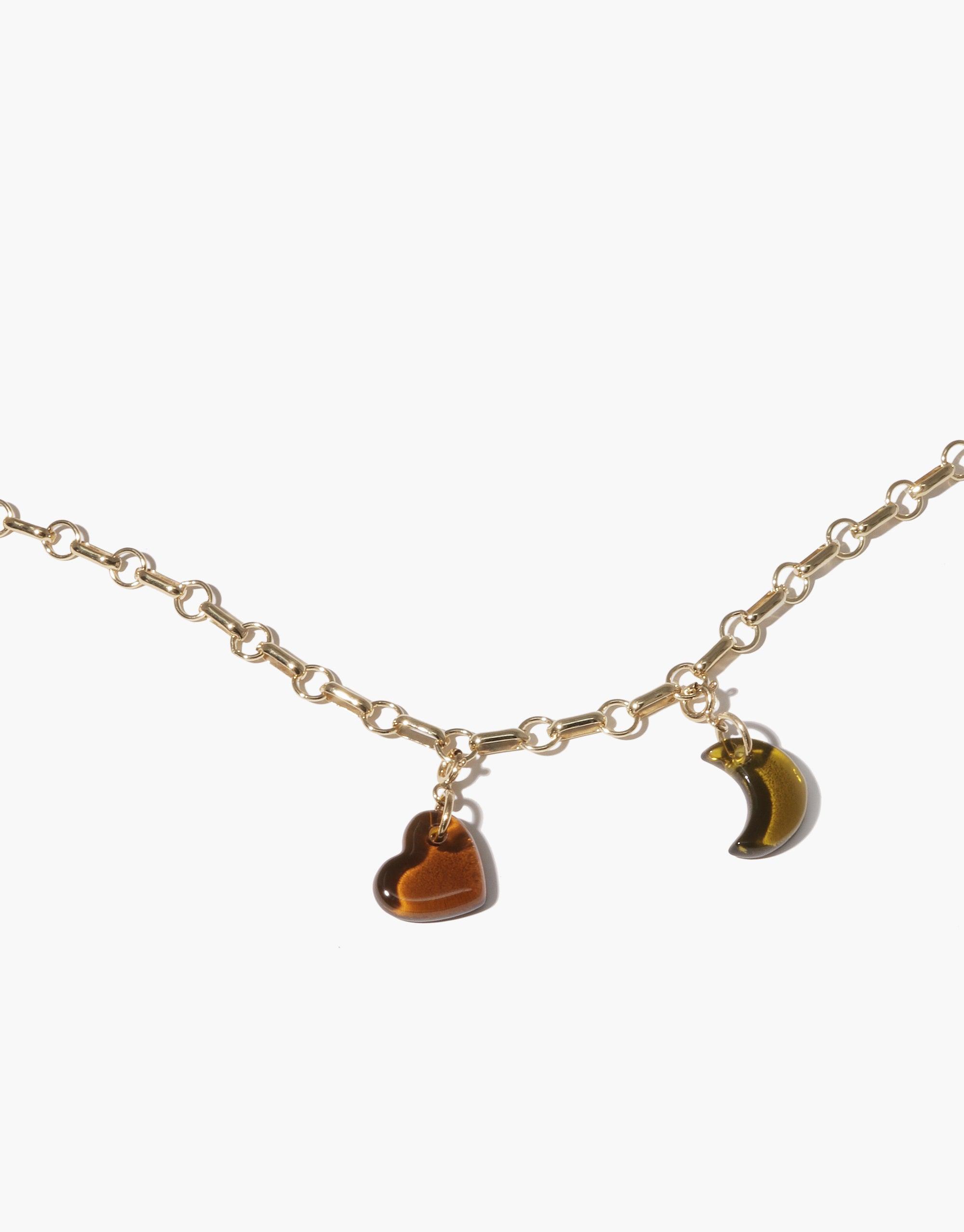 Gold chain necklace with two charms: a brown heart-shaped charm and a crescent moon charm. Delicate and elegant design for the Moon | Icon Charm. Handcrafted jewelry featuring upcycled eco-friendly materials. CLED