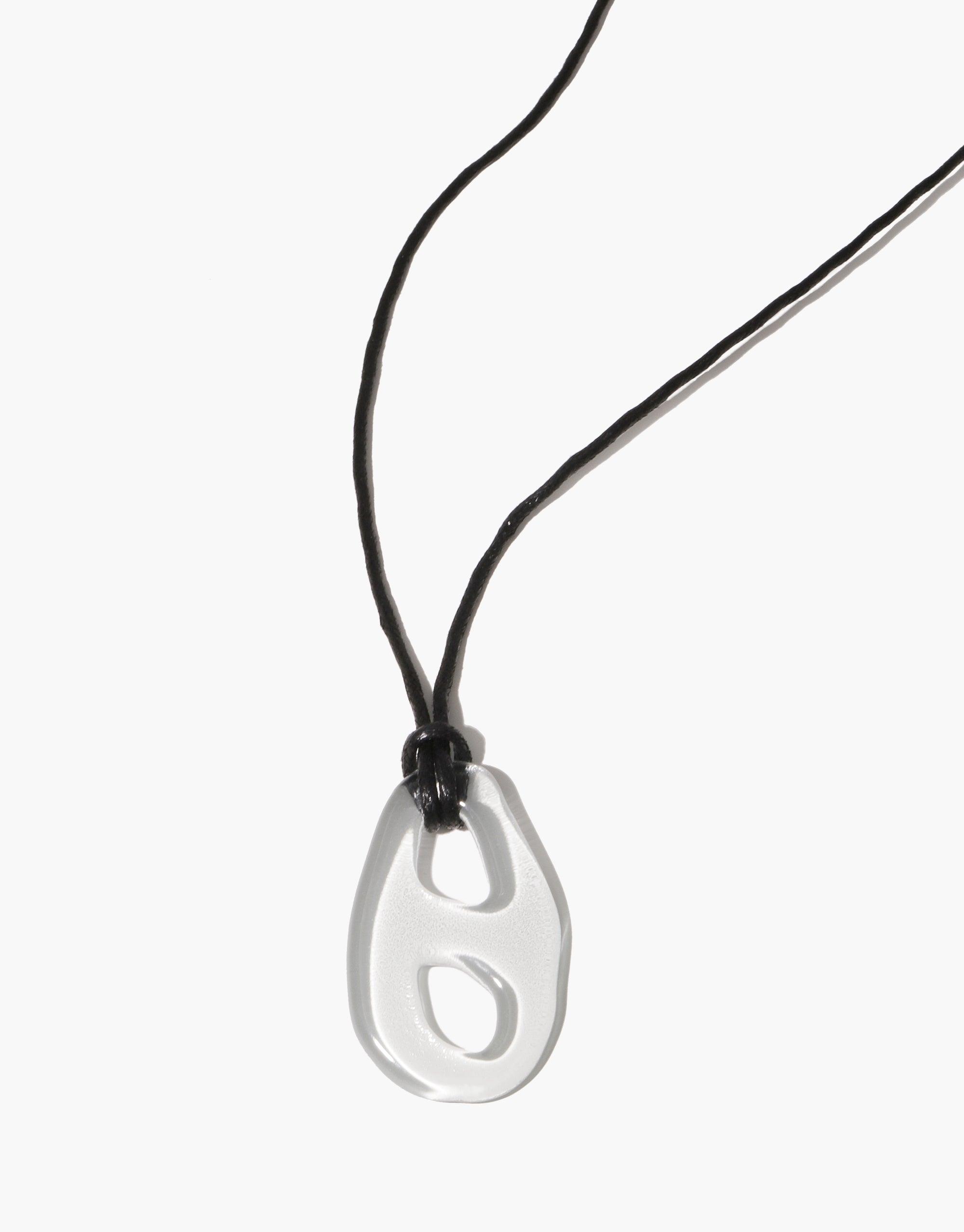Sculptural Large Charm Necklace | B featuring a translucent glass pendant with unique cutout design, suspended on a black cotton cord. Handcrafted upcycled eco-friendly jewelry piece showcasing sustainable artistry. CLED
