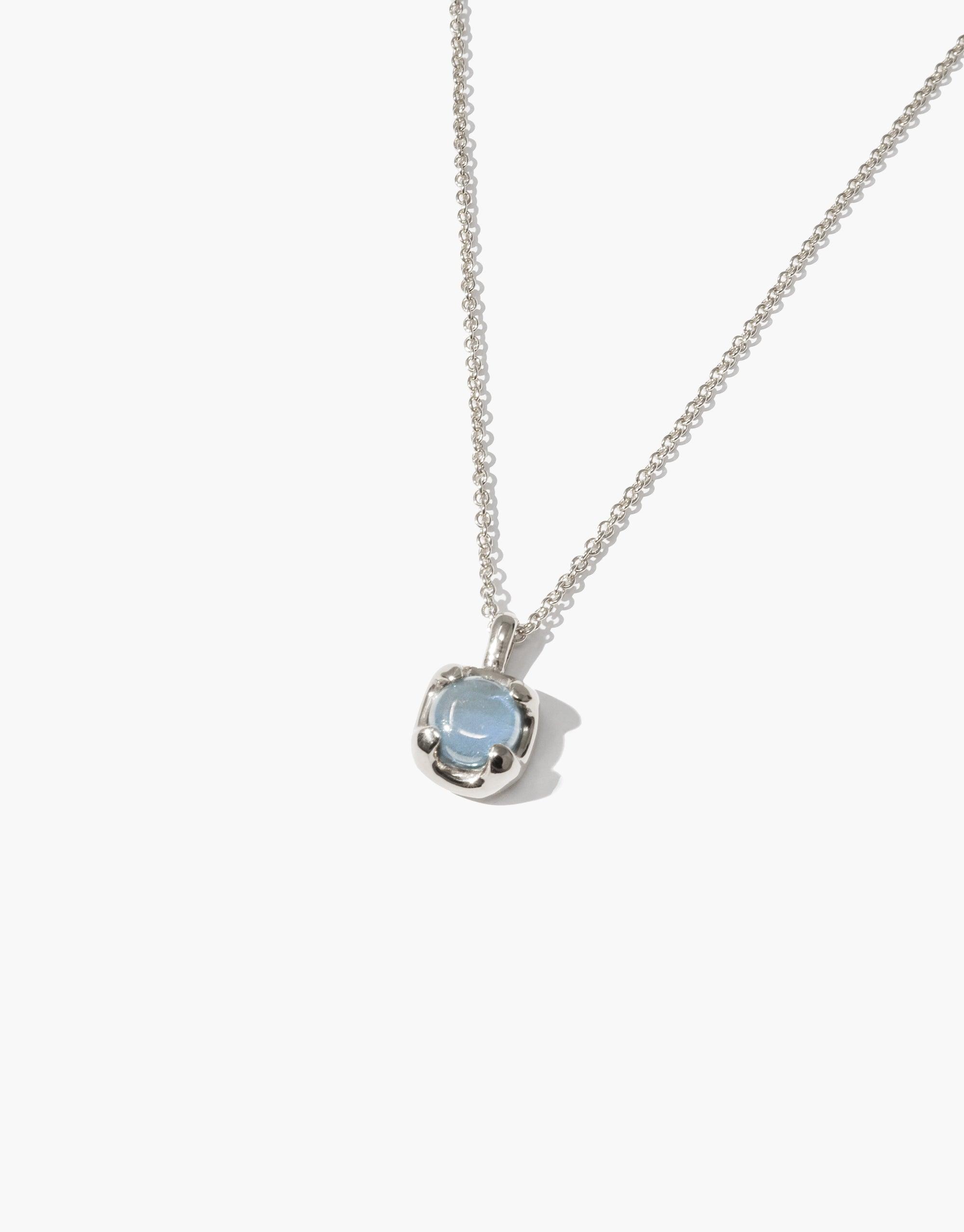 Elegant Beam Necklace featuring a delicate silver chain and a light blue gemstone pendant. The eco-friendly gem is set in a minimalist silver bezel, showcasing sustainable luxury. Perfect for everyday wear or special occasions. Handcrafted with upcycled glass by CLED.