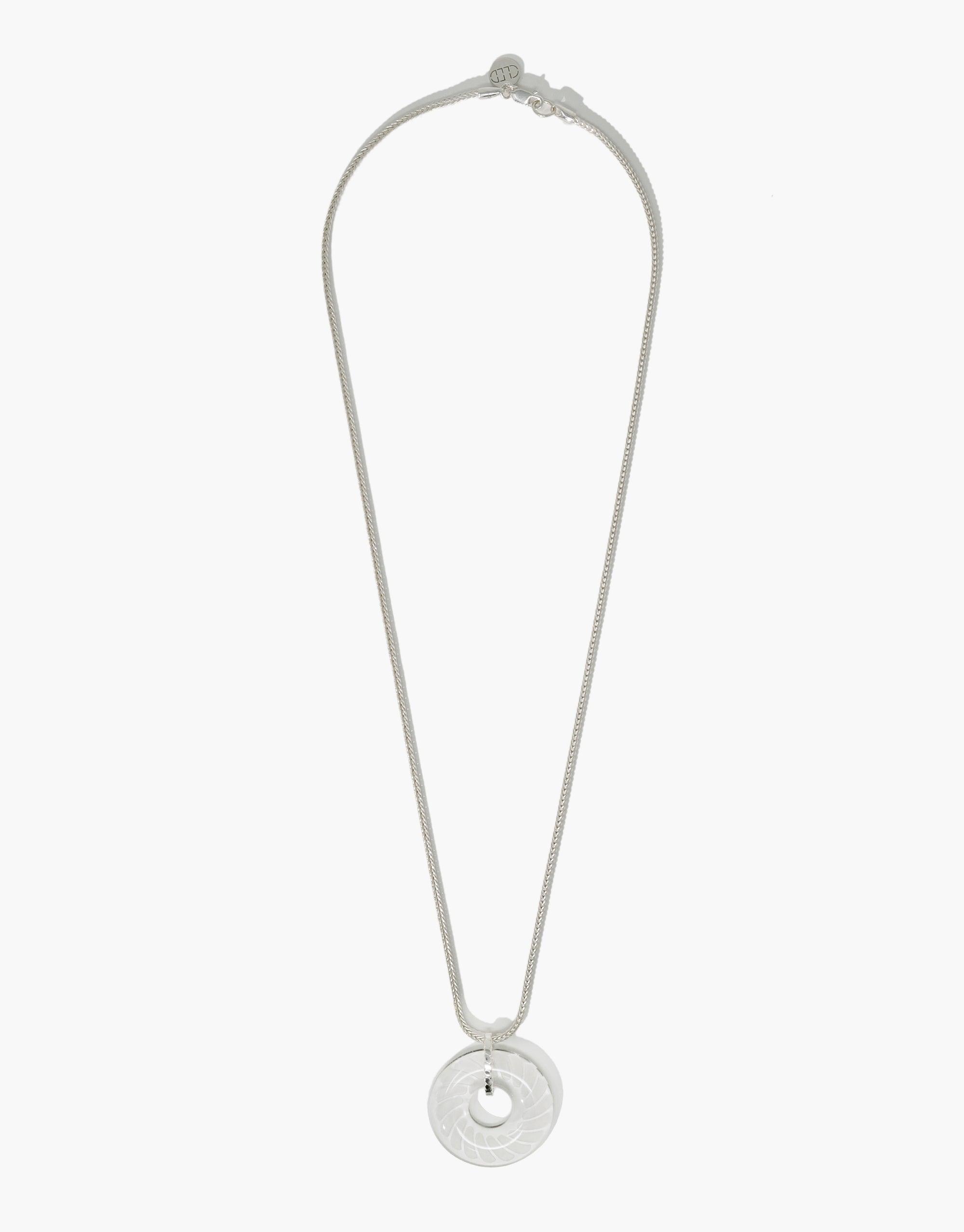 Elegant Braid Necklace featuring a circular eco gem pendant with engraved braid pattern, suspended on a delicate silver chain. Handcrafted from repurposed glass, this sustainable jewelry piece showcases CLED's commitment to eco-friendly fashion and artisanal craftsmanship.