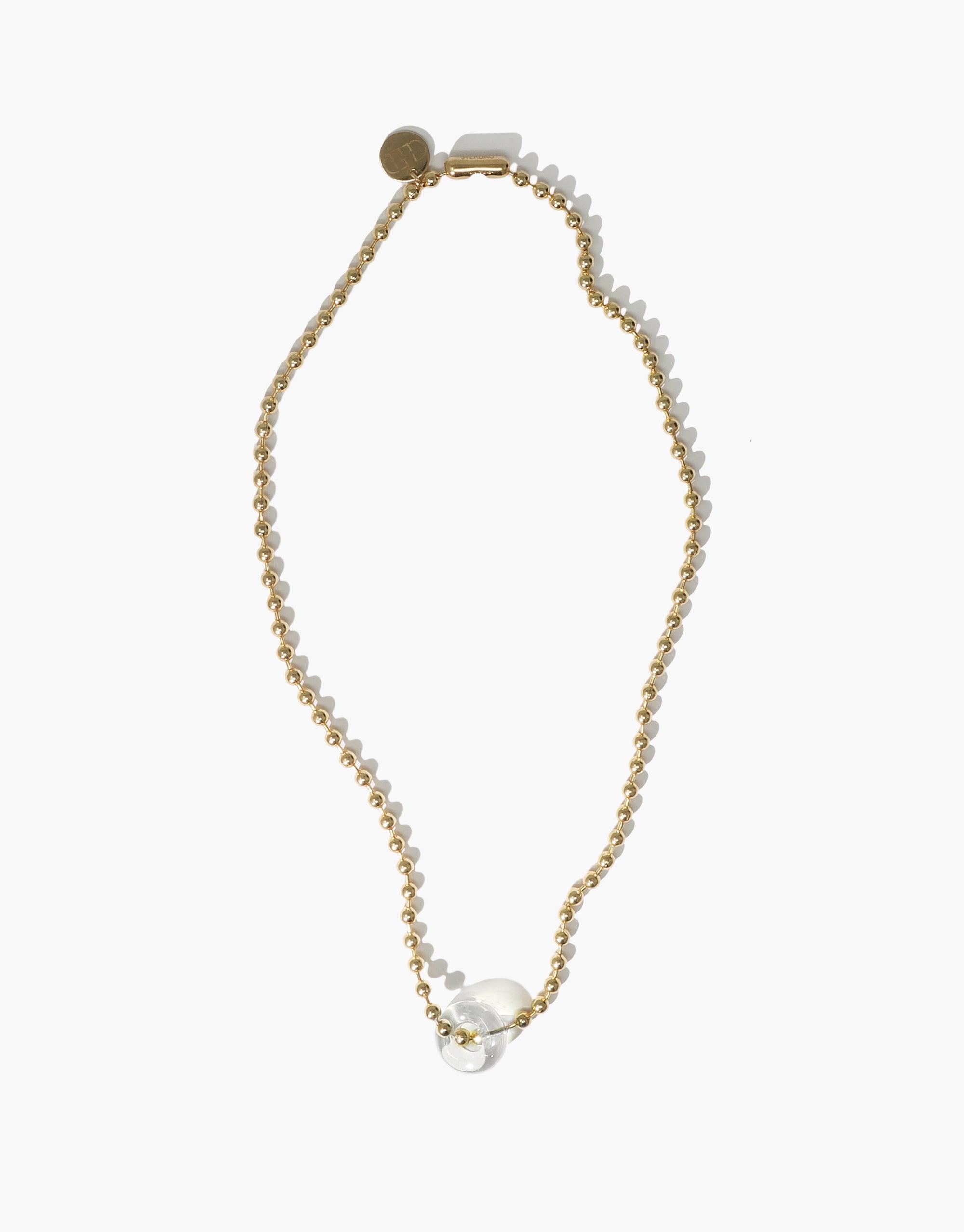 Elegant Donut Ball Necklace featuring a delicate gold chain with a transparent eco gem pendant, showcasing sustainable luxury and prismatic beauty. Handcrafted design perfect for eco-conscious fashion lovers. CLED
