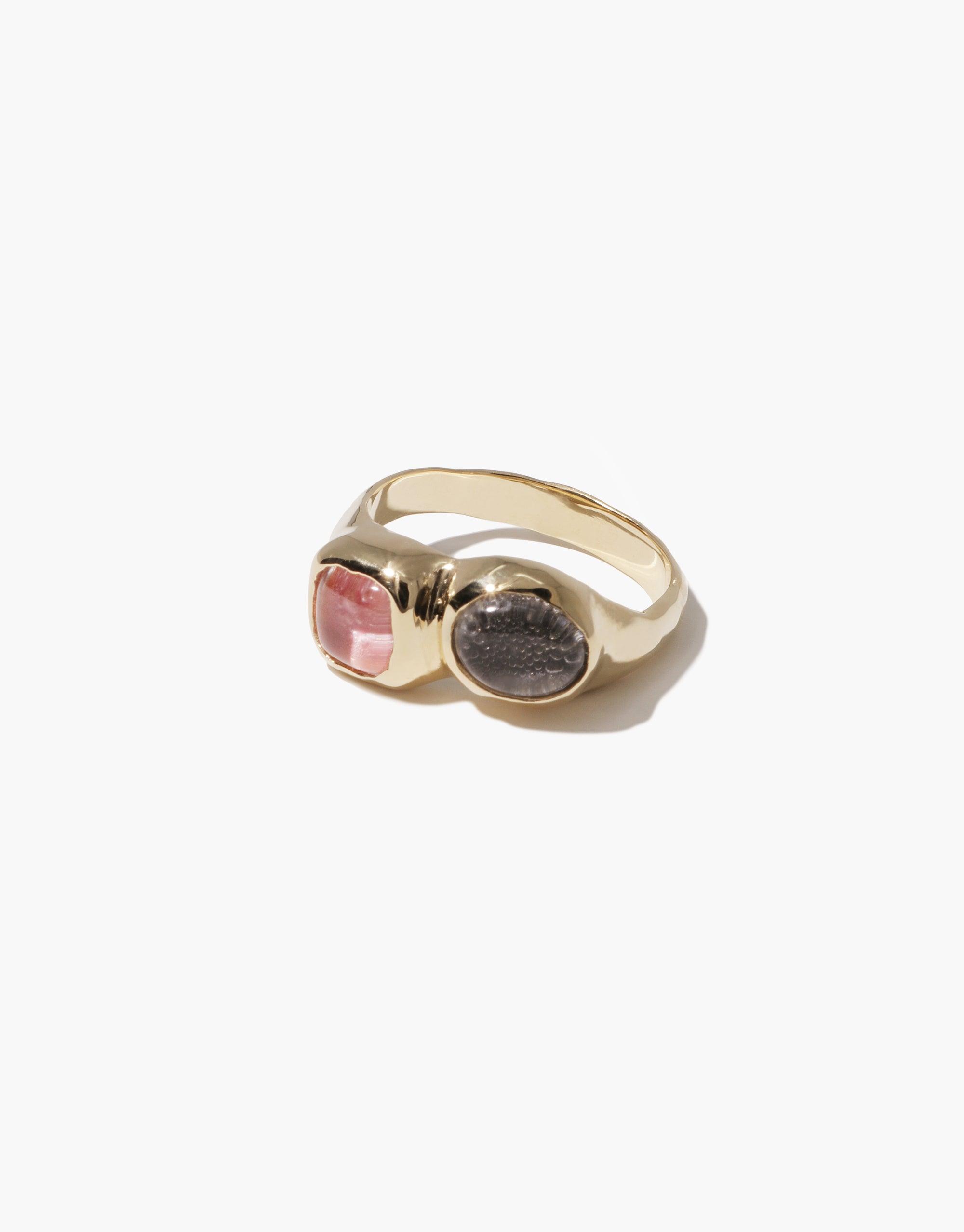 Duo Sculpture Ring featuring two contrasting eco gems, one pink and one gray, set in a sleek gold-toned band. Elegant and sustainable jewelry design showcasing upcycled glass. Handcrafted with attention to detail. CLED