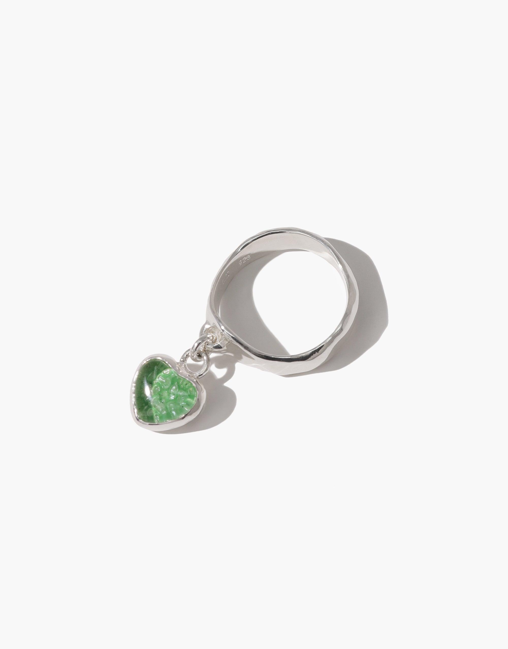 Sterling silver ring with dangling green heart charm, featuring upcycled eco glass. Elegant and sustainable Heart Dangling Ring design, handcrafted in Los Angeles. Perfect for eco-conscious jewelry lovers. CLED