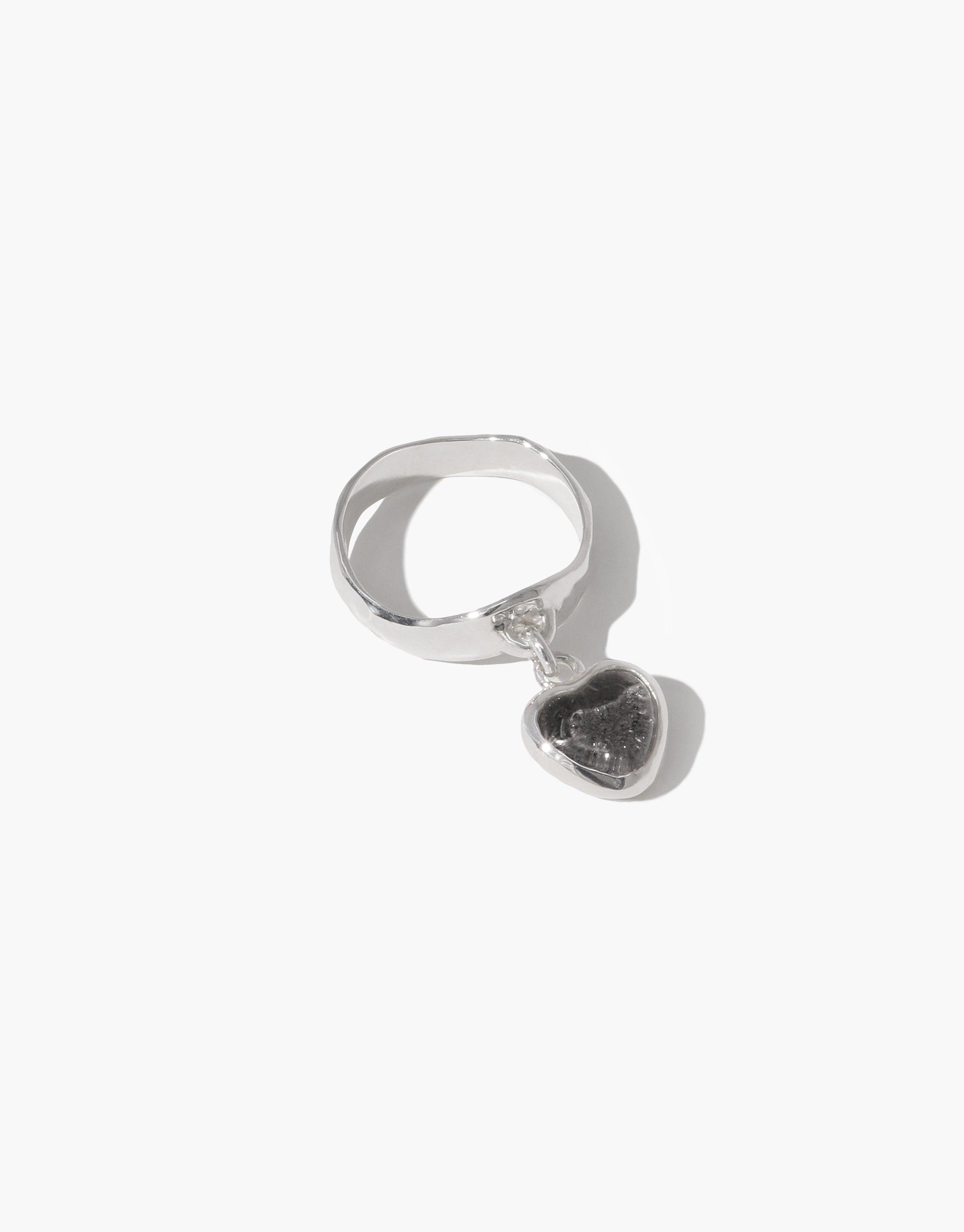 Sterling silver Heart Dangling Ring featuring a unique eco-friendly charm made from upcycled glass. Handcrafted design with a playful heart-shaped pendant suspended from a sleek band. Sustainable and stylish jewelry piece by CLED.