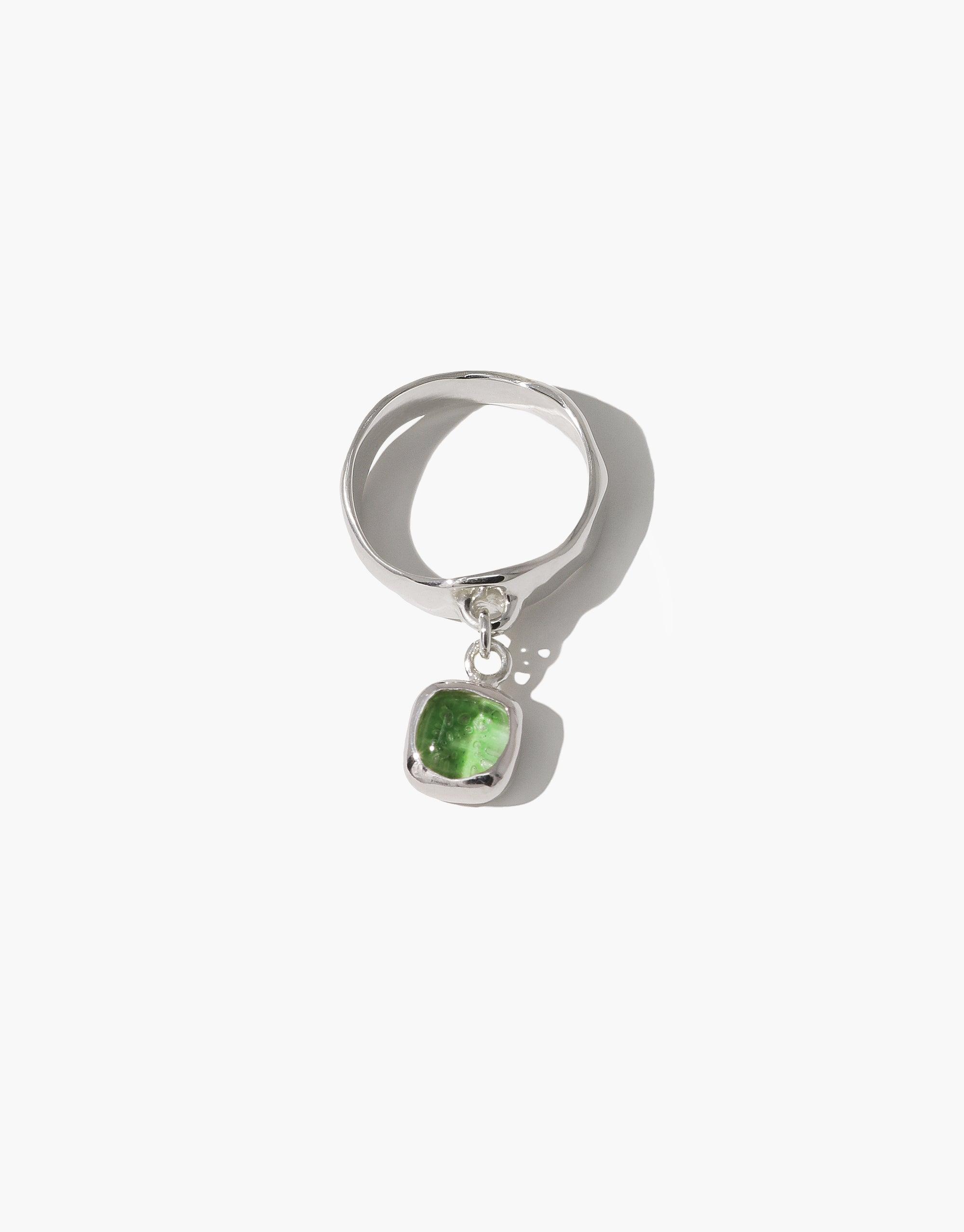 Square Dangling Ring featuring a green Eco Gem, crafted from upcycled glass, set on a sterling silver band. The piece elegantly showcases CLED's commitment to eco-conscious jewelry.