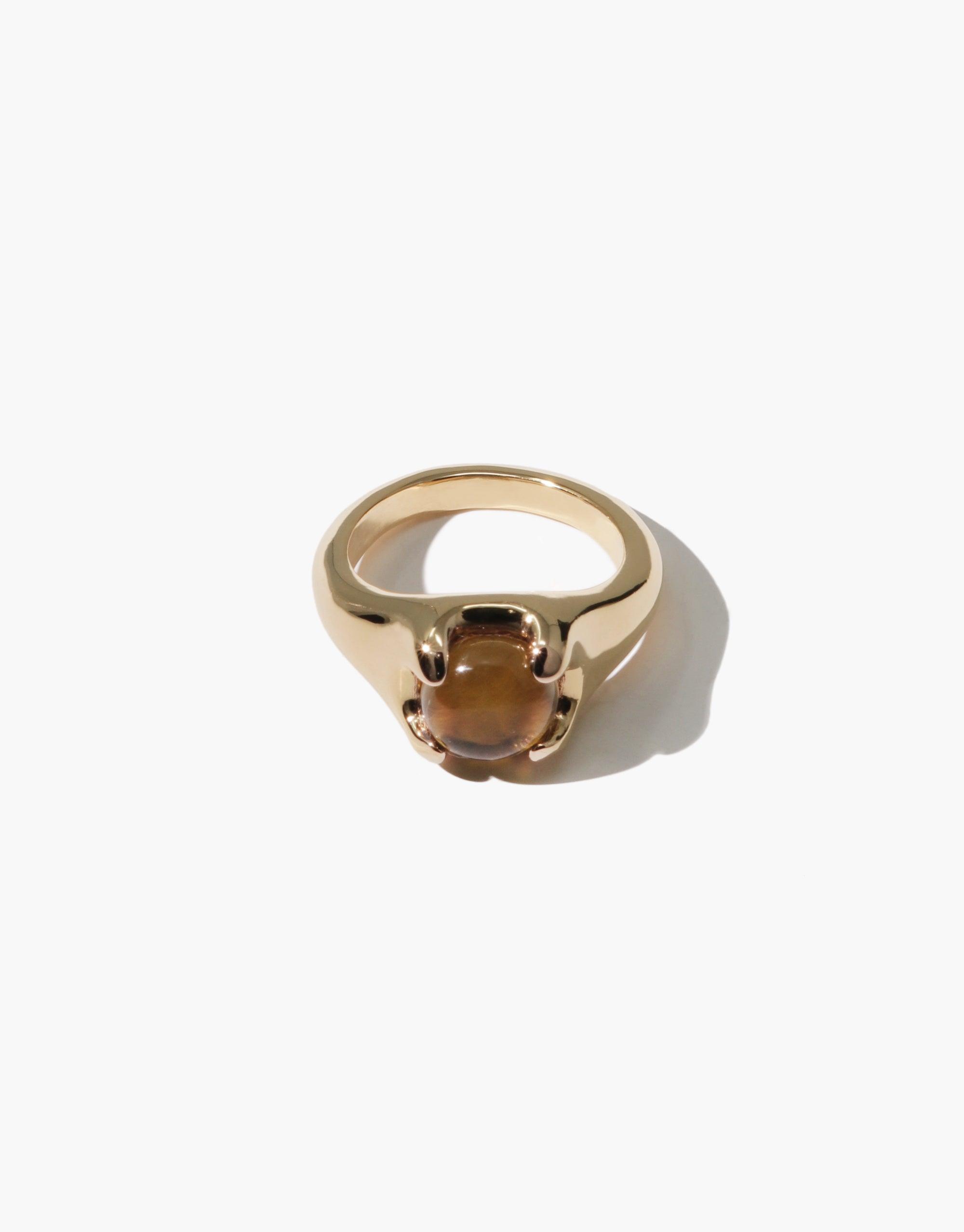 Beam Ring featuring a golden band with a prism-like amber gemstone, showcasing a unique eco-friendly design inspired by rays of light. Handcrafted jewelry piece with a sustainable approach by CLED.