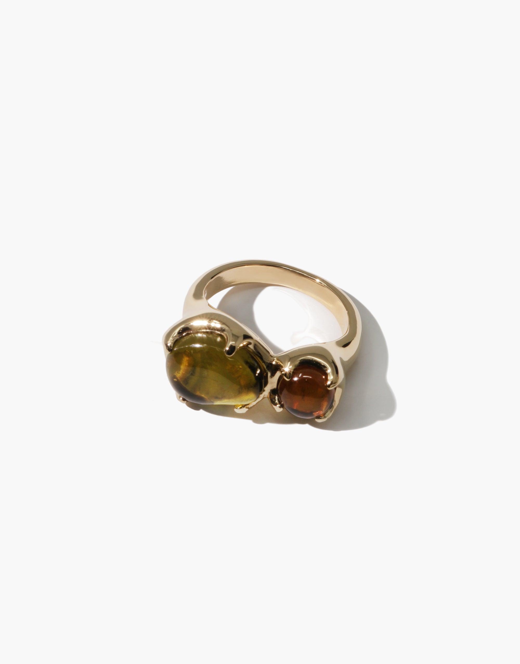 Gold-toned ring with two eco gems: a large oval amber-colored stone and a smaller round brown stone, showcasing unique design of Duo Beam Ring by CLED