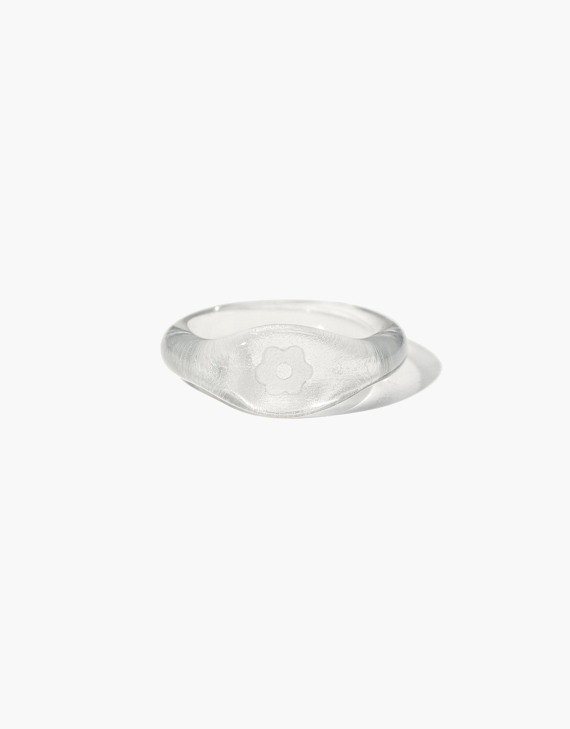 Avens Signet Ring featuring a clear glass band with engraved flower symbol. Eco-friendly, handmade jewelry piece from the Messenger Collection. Sustainable and stylish accessory by CLED.