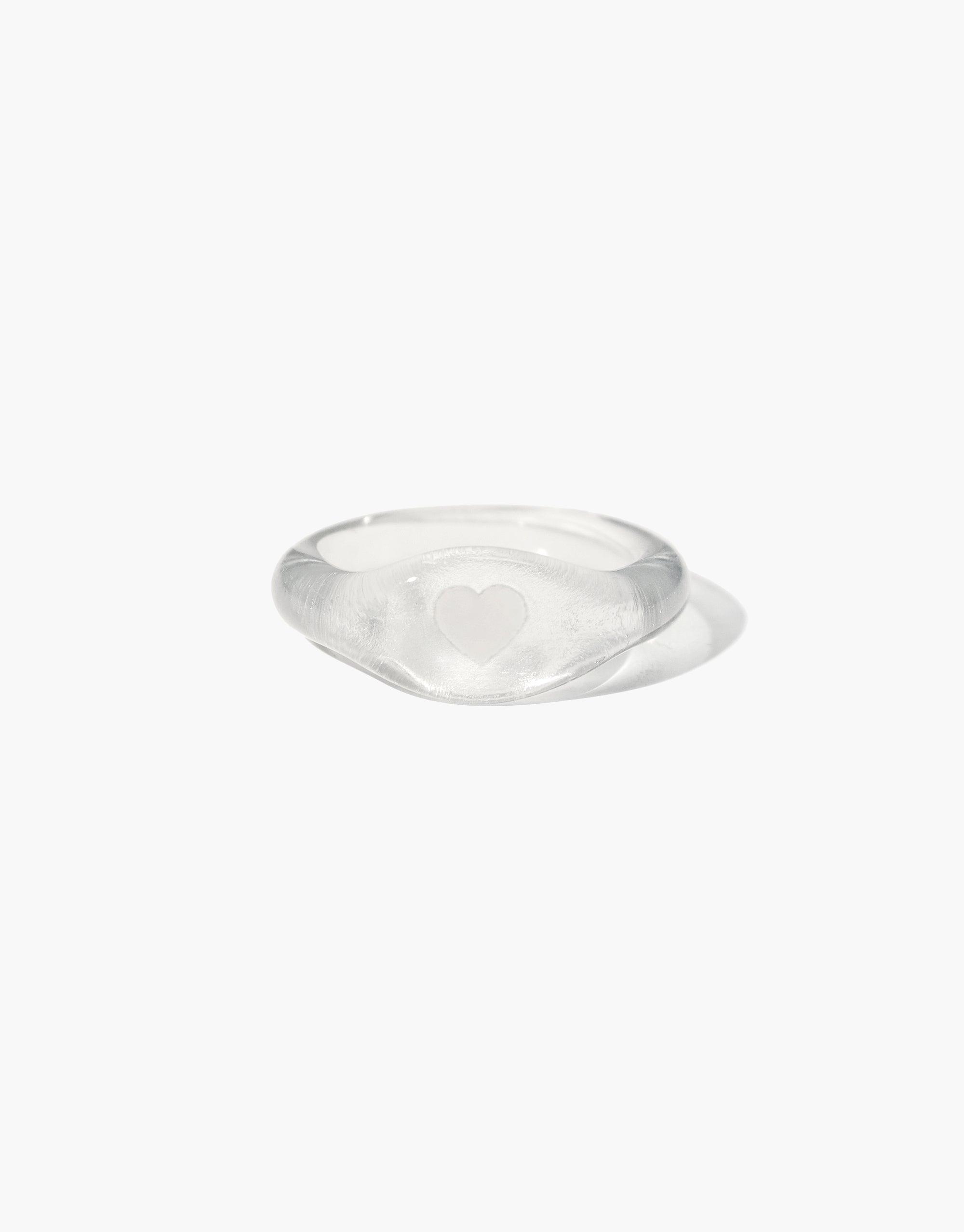 Clear glass Heart Signet Ring with engraved heart symbol, part of the Messenger Collection. Handcrafted from eco-friendly repurposed glass, available in various sizes. Elegant and sustainable jewelry piece by CLED.