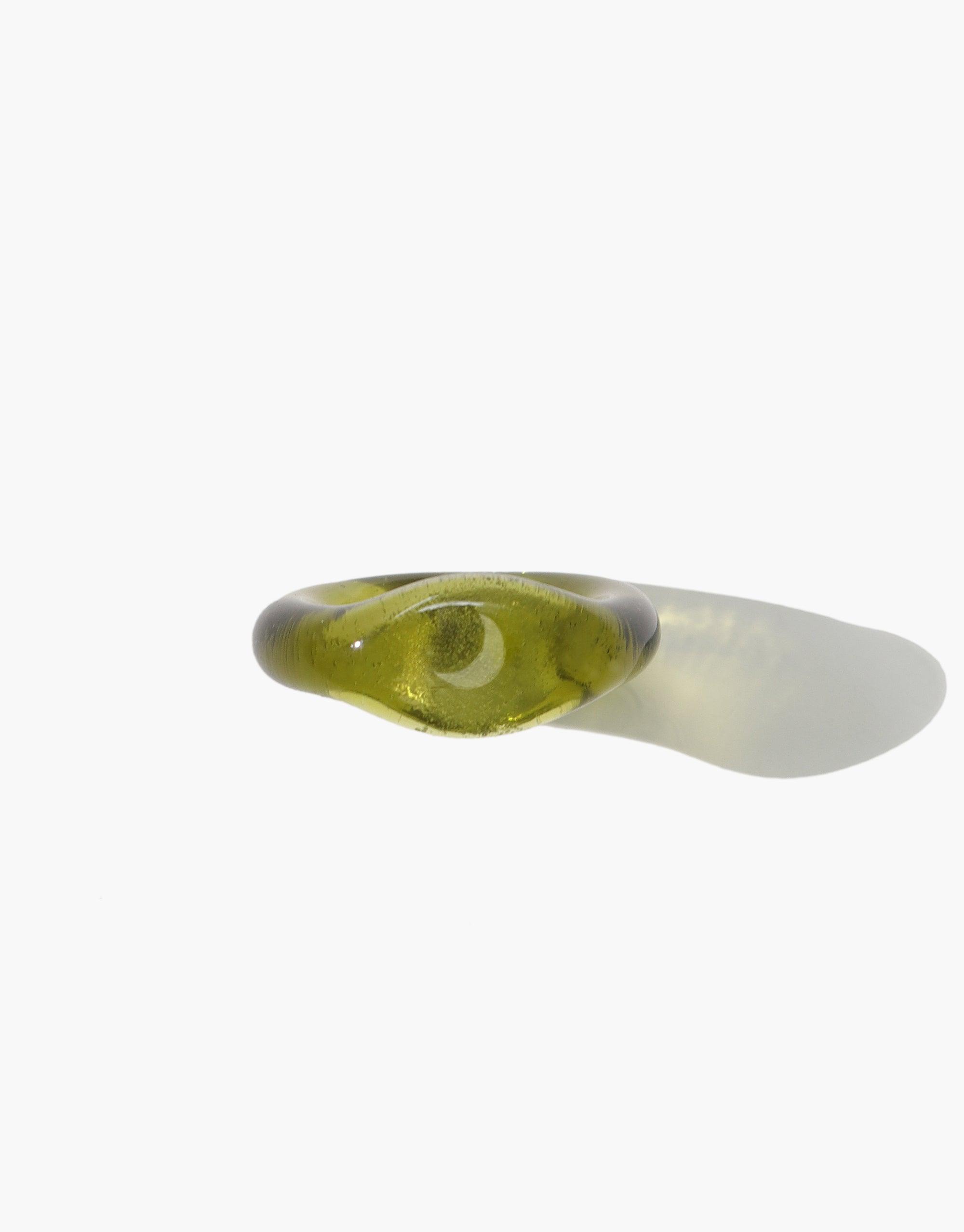 Moon Signet Ring featuring a clear engraved moon symbol on a translucent olive green eco-friendly glass band, handcrafted from repurposed glass. Sustainable and stylish jewelry piece from the Messenger Collection by CLED.