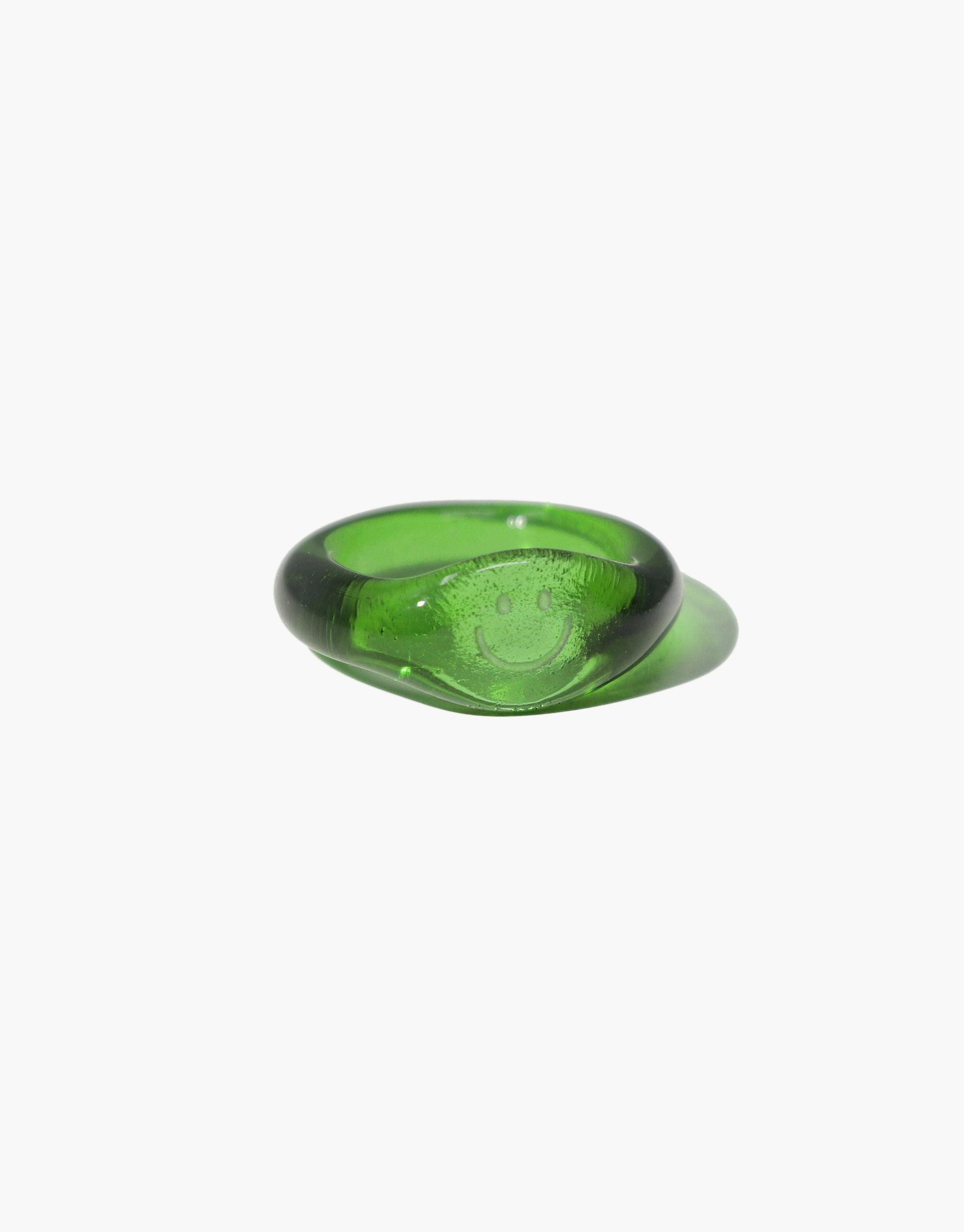 Smile Signet Ring featuring a vibrant green eco gem made from repurposed glass, showcasing a clear engraved smile symbol. Handcrafted sustainable jewelry piece from the Messenger Collection by CLED.