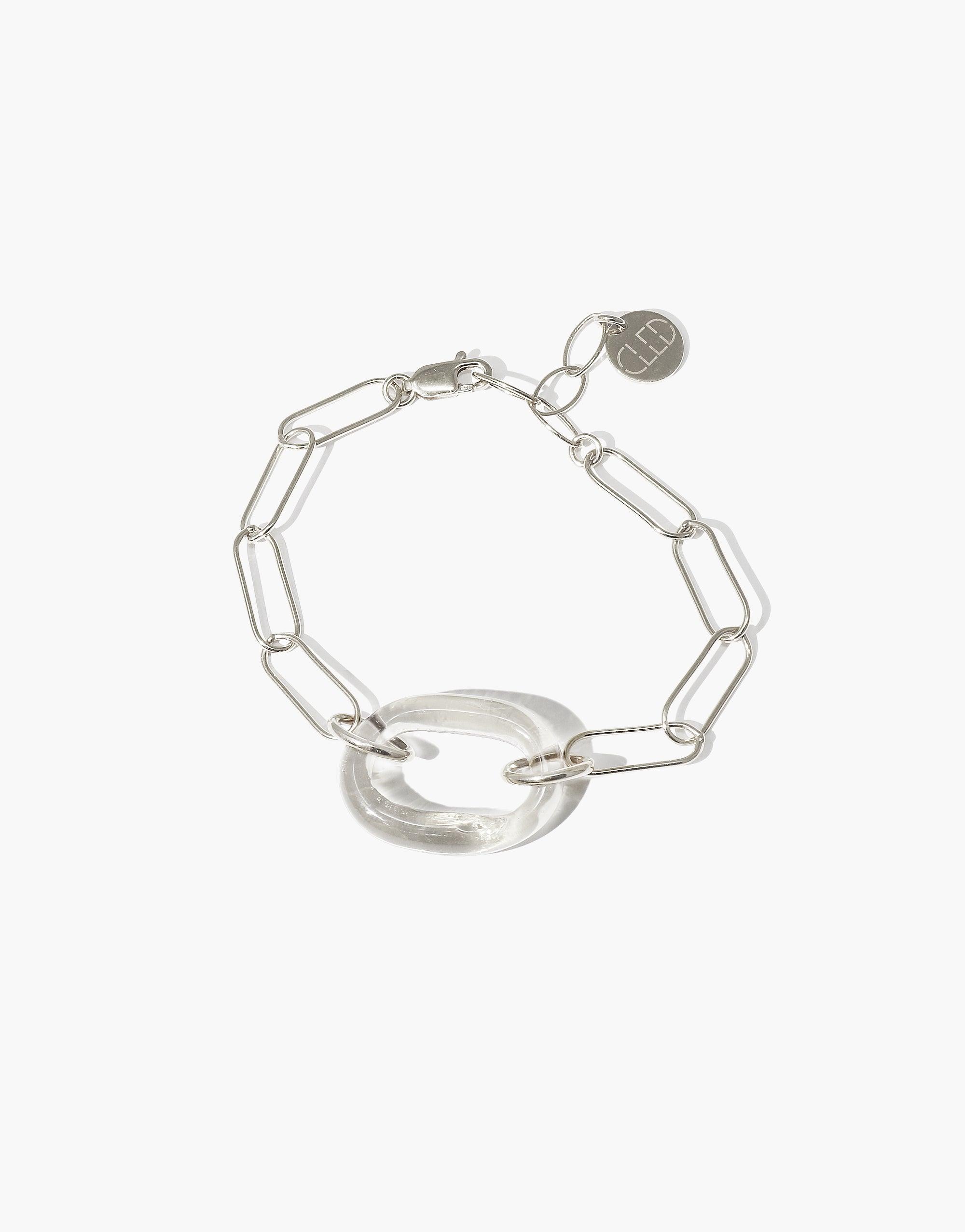 The Day Loop Bracelet features a silver oval chain with a clear Eco Gem ring, showcasing CLED's eco-conscious design and craftsmanship, handmade in Los Angeles from repurposed glass.