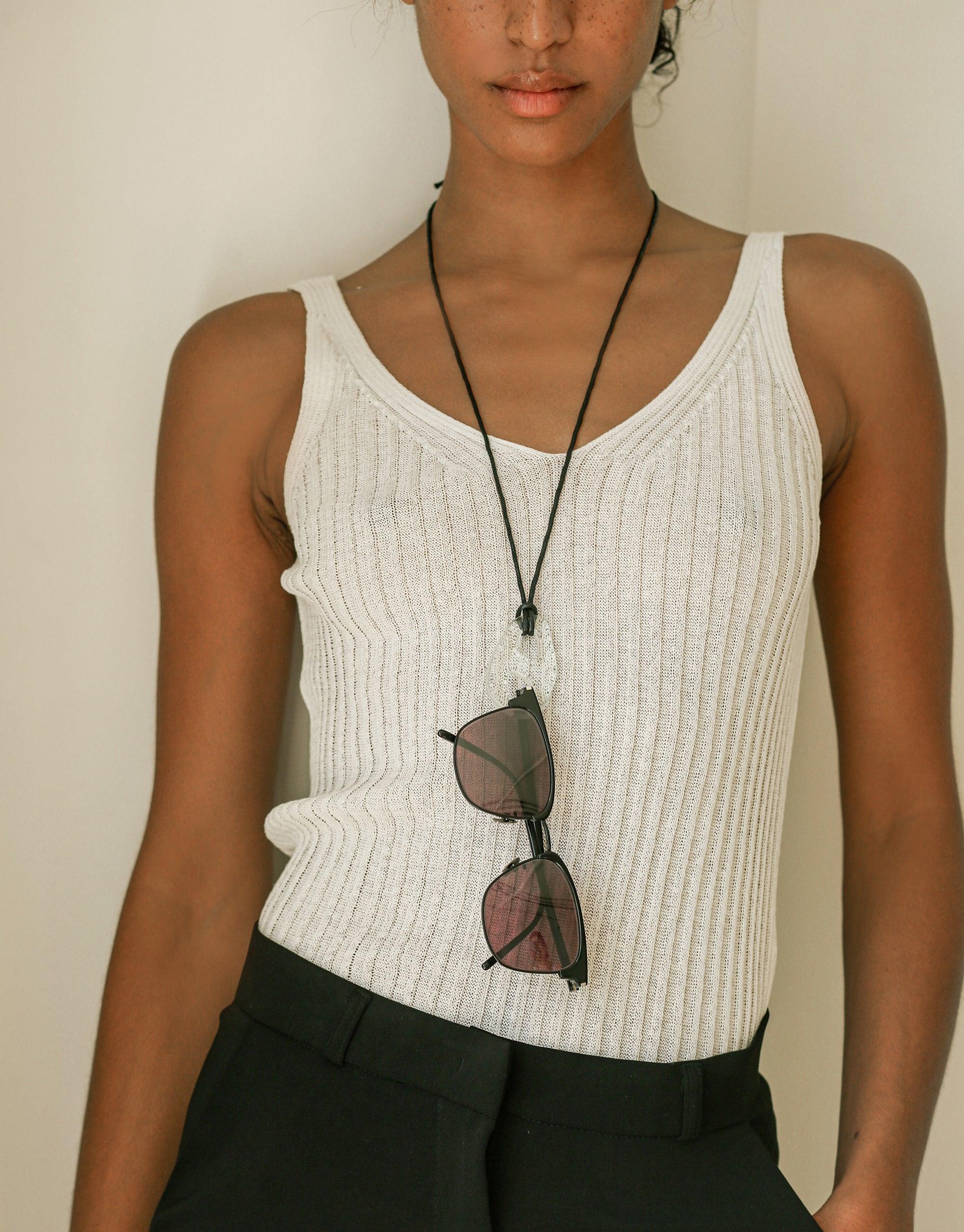 Sculptural Large Charm Necklace | B featuring upcycled glass charm on adjustable cotton cord, worn with ribbed white tank top and sunglasses. Handmade eco-friendly jewelry by CLED.