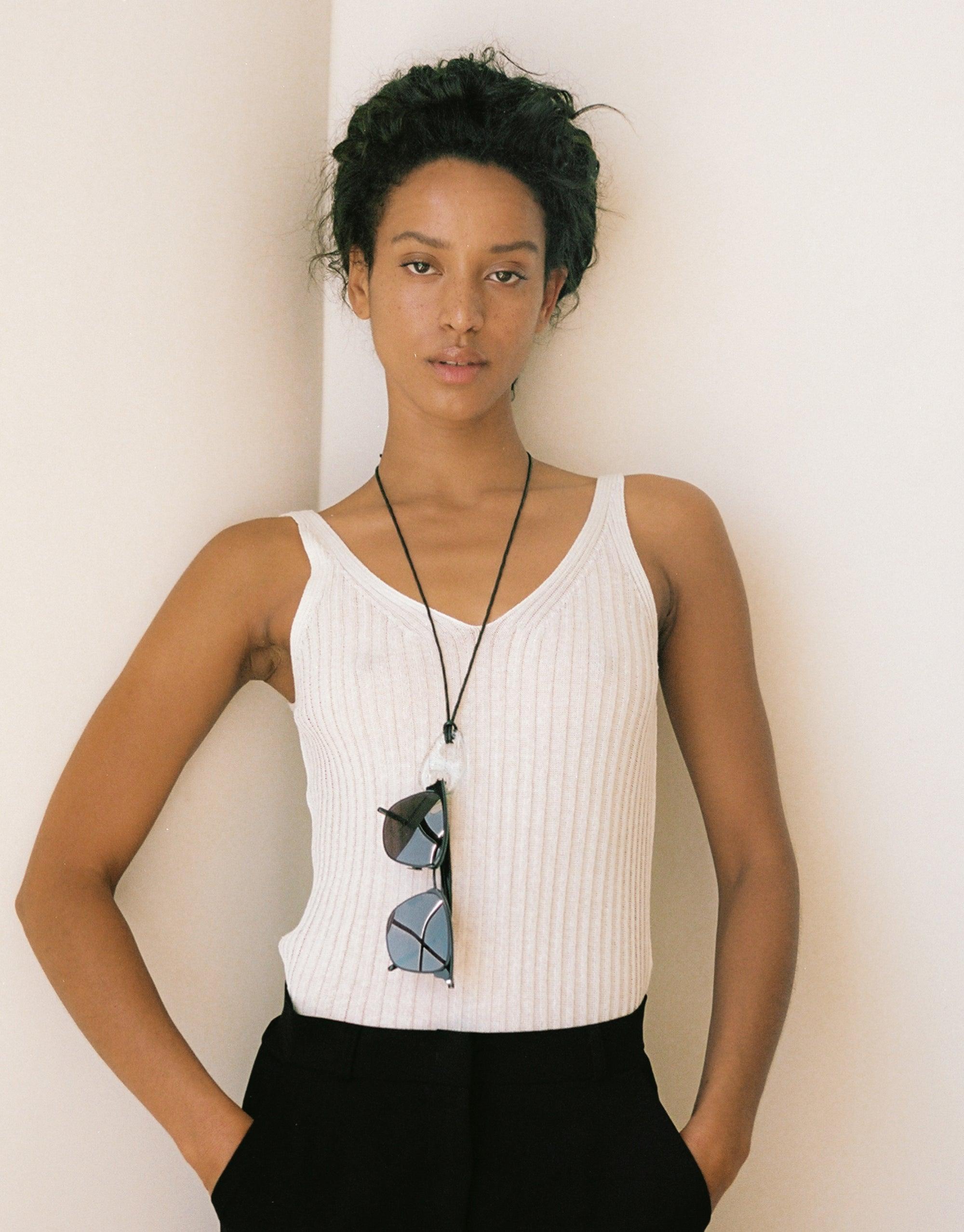 Sculptural Large Charm Necklace | B featuring upcycled glass charm on adjustable cotton cord, worn with white tank top and black bottom. Eco-friendly, handmade jewelry by CLED.