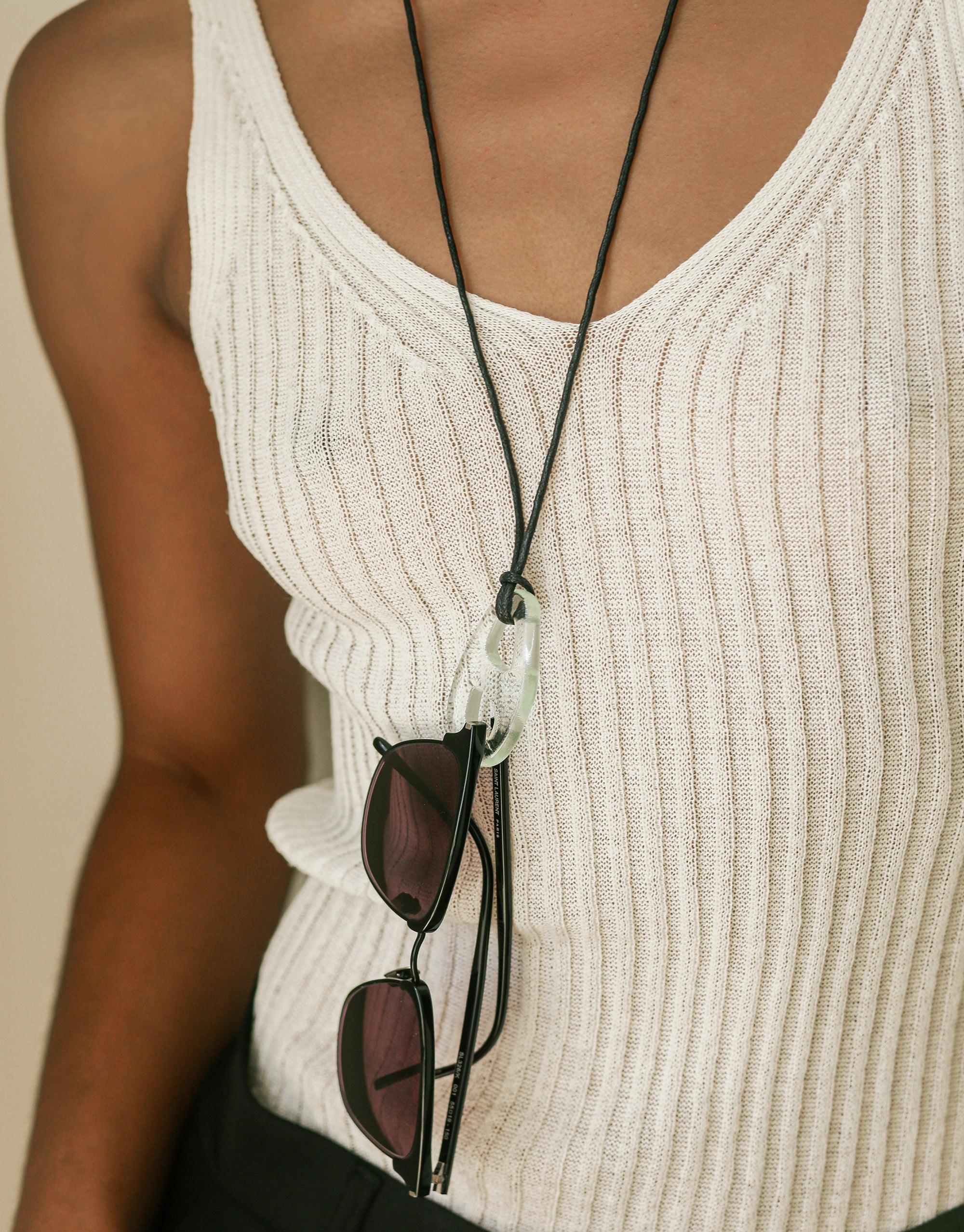 Sculptural Large Charm Necklace | B featuring upcycled glass charm on adjustable cotton cord, worn with white ribbed tank top and sunglasses. Handmade eco-friendly jewelry by CLED.
