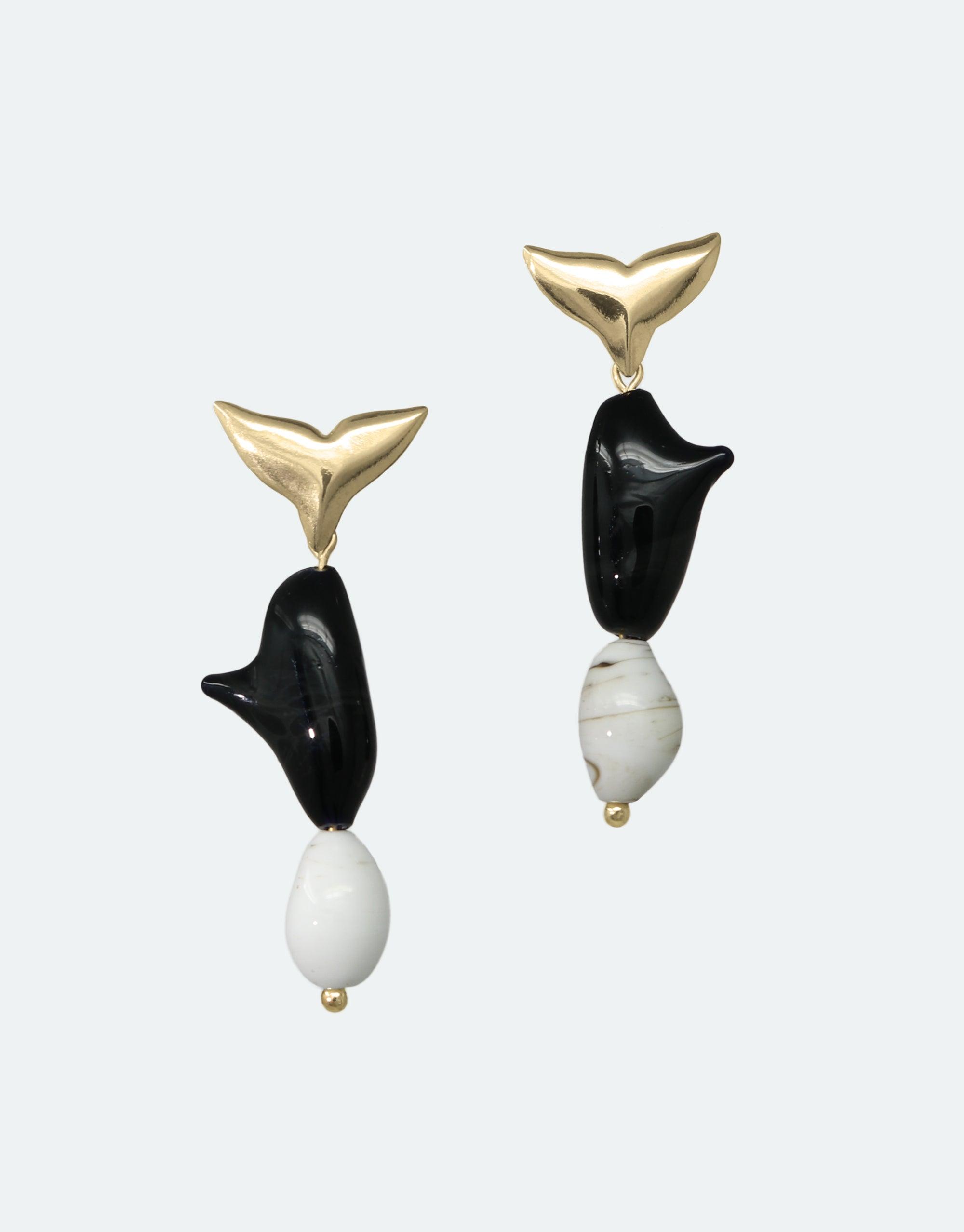 Elegant Orca Earrings featuring gold whale tails, black bodies, and white accents. Handcrafted eco-friendly jewelry inspired by marine life and climate awareness. Floating Glacier Collection by CLED. Orca Earrings.