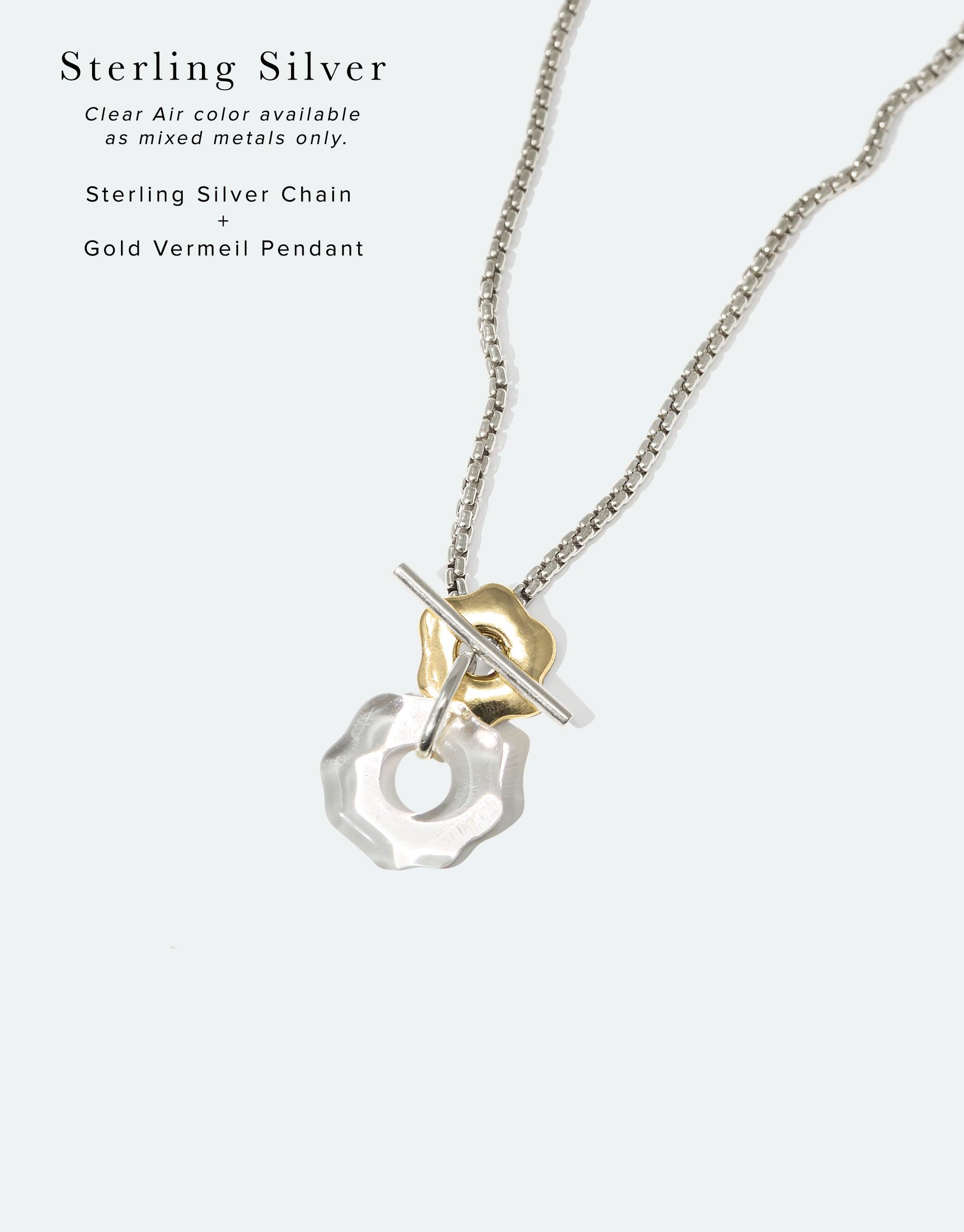 Avens Toggle Necklace featuring sterling silver chain with gold vermeil pendant and clear eco gem. Mixed metal design inspired by Arctic flora. Sustainable jewelry showcasing climate awareness. CLED