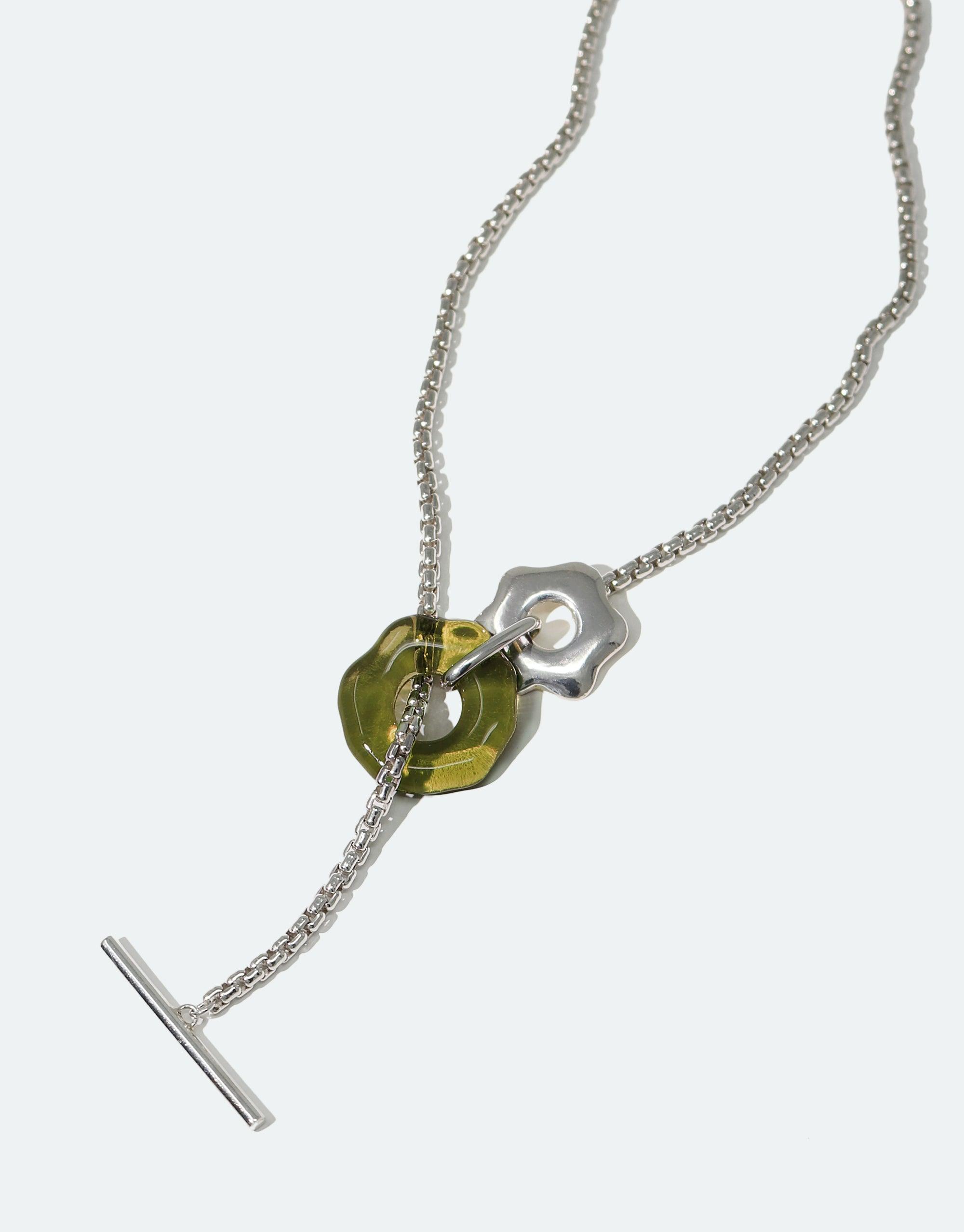 Elegant Avens Toggle Necklace featuring a delicate silver chain, green glass eco gem pendant, and floral-inspired toggle closure. Versatile design inspired by Arctic flora and climate awareness. Handcrafted sustainable jewelry by CLED.