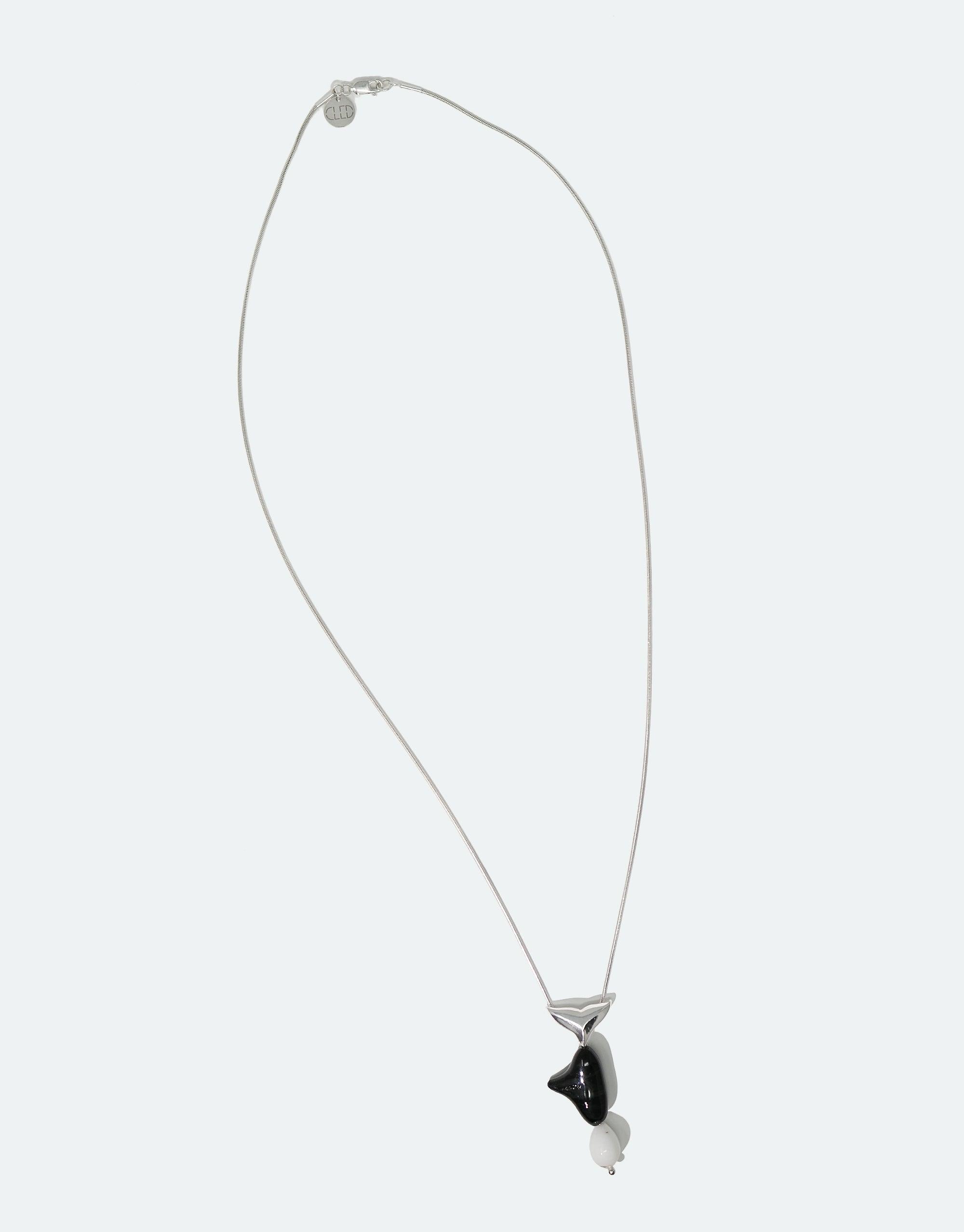Elegant Orca Necklace featuring a stylized black and white whale pendant on a delicate silver chain, part of the Floating Glacier Collection. Handcrafted eco-friendly jewelry raising awareness for endangered marine life. Orca Necklace by CLED