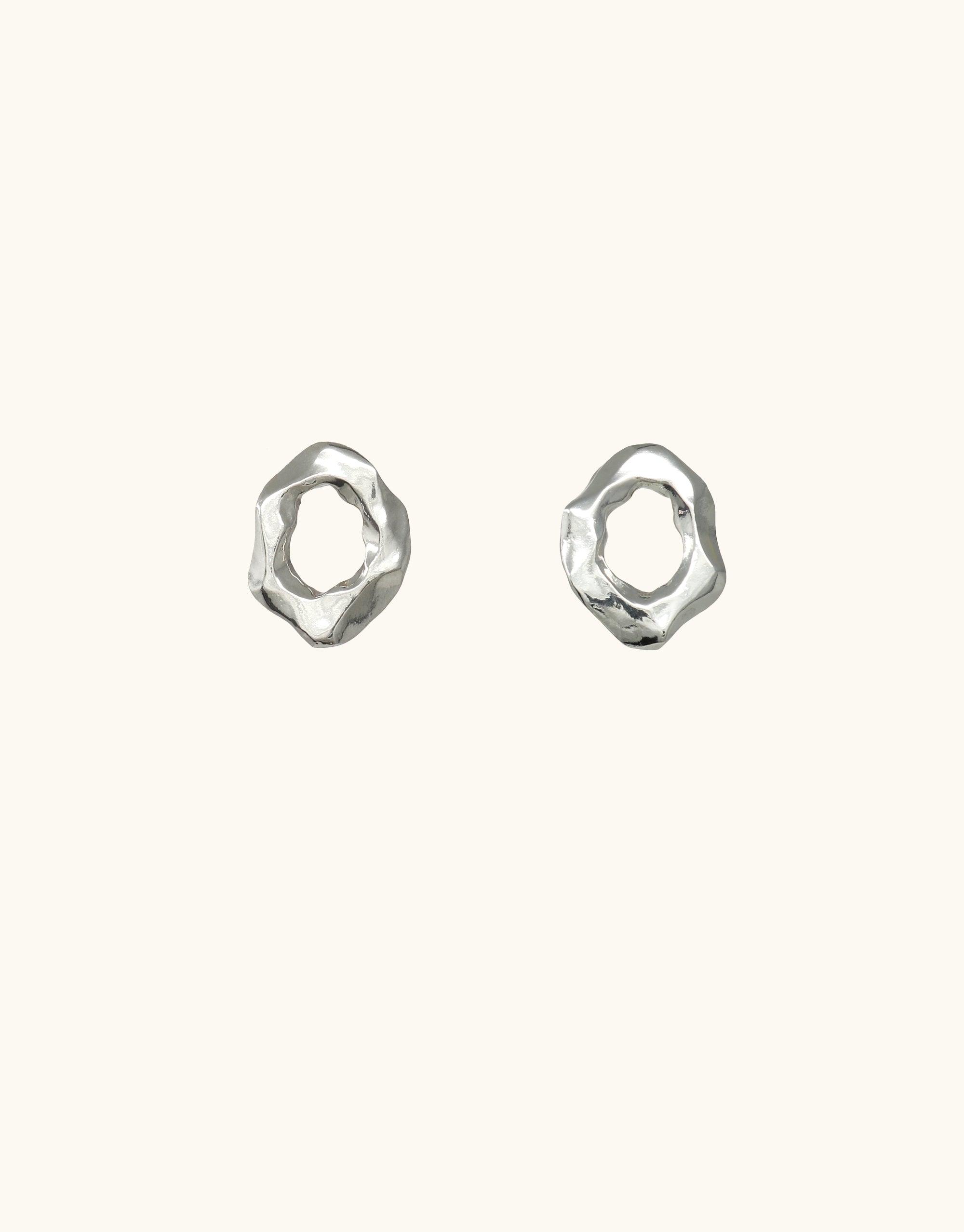 Canyon Stud Earrings featuring abstract, organic shapes inspired by canyon terrain. Handcrafted silver earrings with unique molten forms and curved edges, representing the beauty of natural landscapes. Elegant and versatile jewelry piece from the Terrain Collection by CLED.