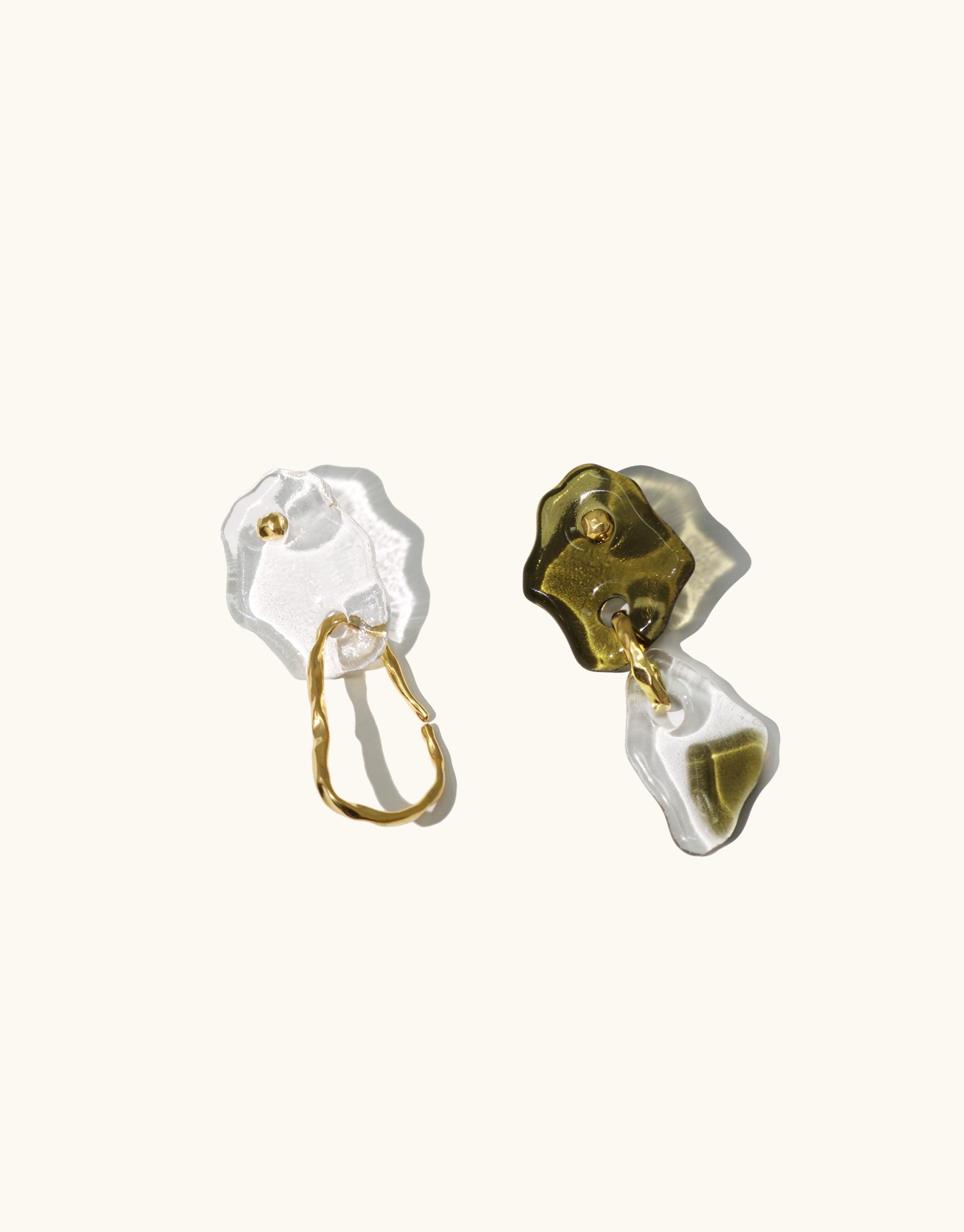 Handcrafted Peak Earrings featuring mismatched glass charms in clear and olive green, inspired by canyon terrain. Gold vermeil hooks and layered eco-friendly glass forms create an abstract, sculptural design. Unique, sustainable jewelry from the Terrain Collection by CLED.