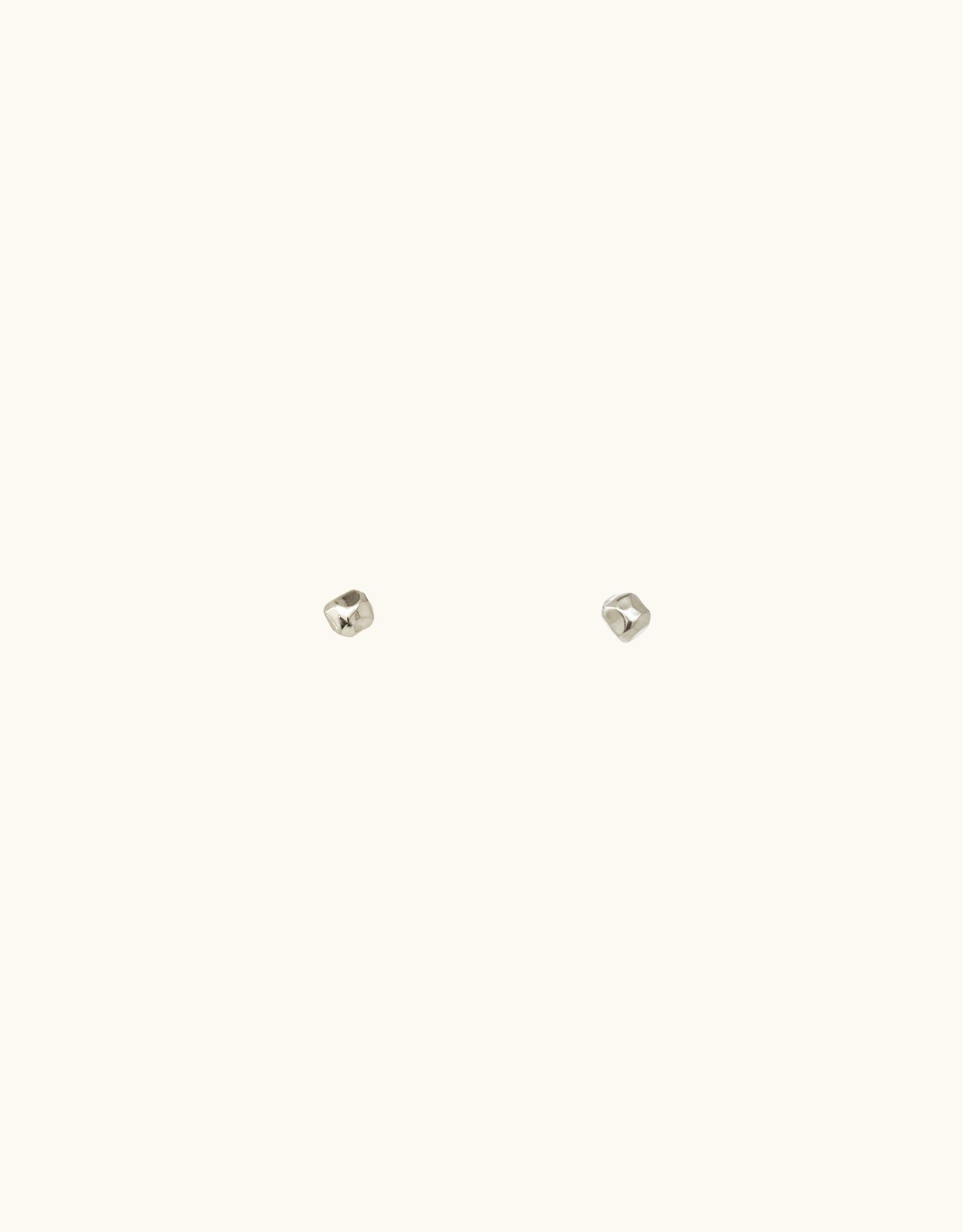 Minimal silver stud earrings from the Terrain Collection, inspired by canyon formations. Abstract molten forms in a small, versatile design. Handcrafted in Los Angeles. Pebble Stud Earrings by CLED.