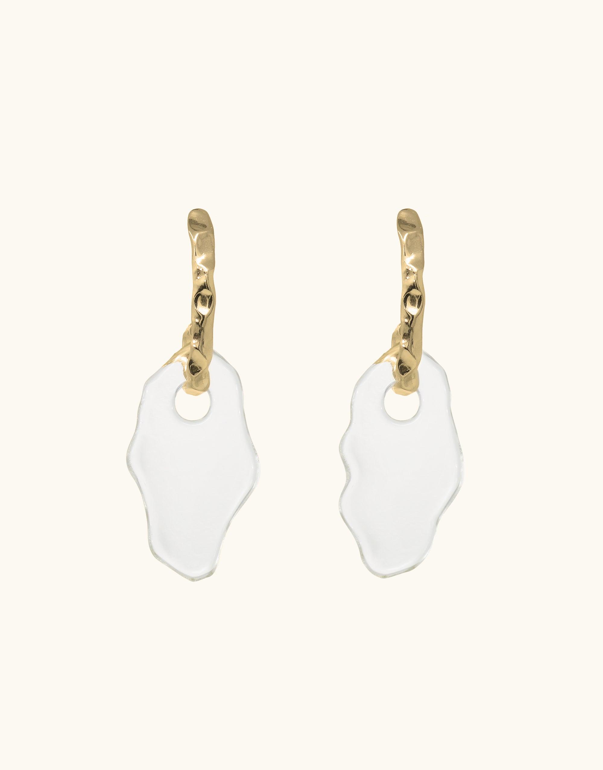 Gold-toned curved earrings with irregular white glass drops, inspired by canyon terrain. Handmade statement piece from eco-friendly repurposed glass, part of the Terrain Collection. Rock Spire Earrings by CLED.