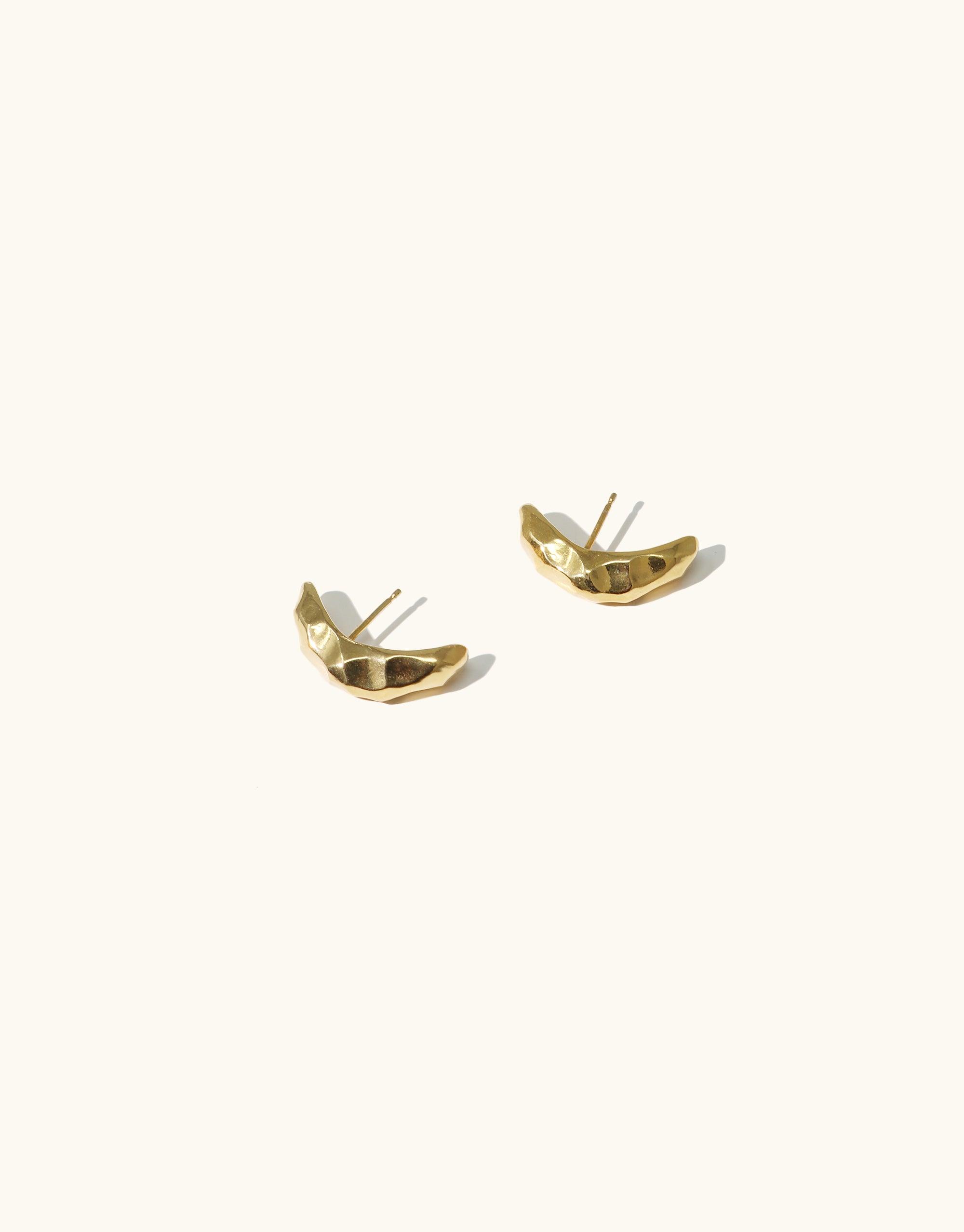 Elegant gold-toned Rock Stud Earrings featuring curved, textured design inspired by canyon terrain. Handmade in Los Angeles, these versatile studs from the Terrain Collection offer a stylish accent for day or night wear. CLED Rock Stud Earrings.