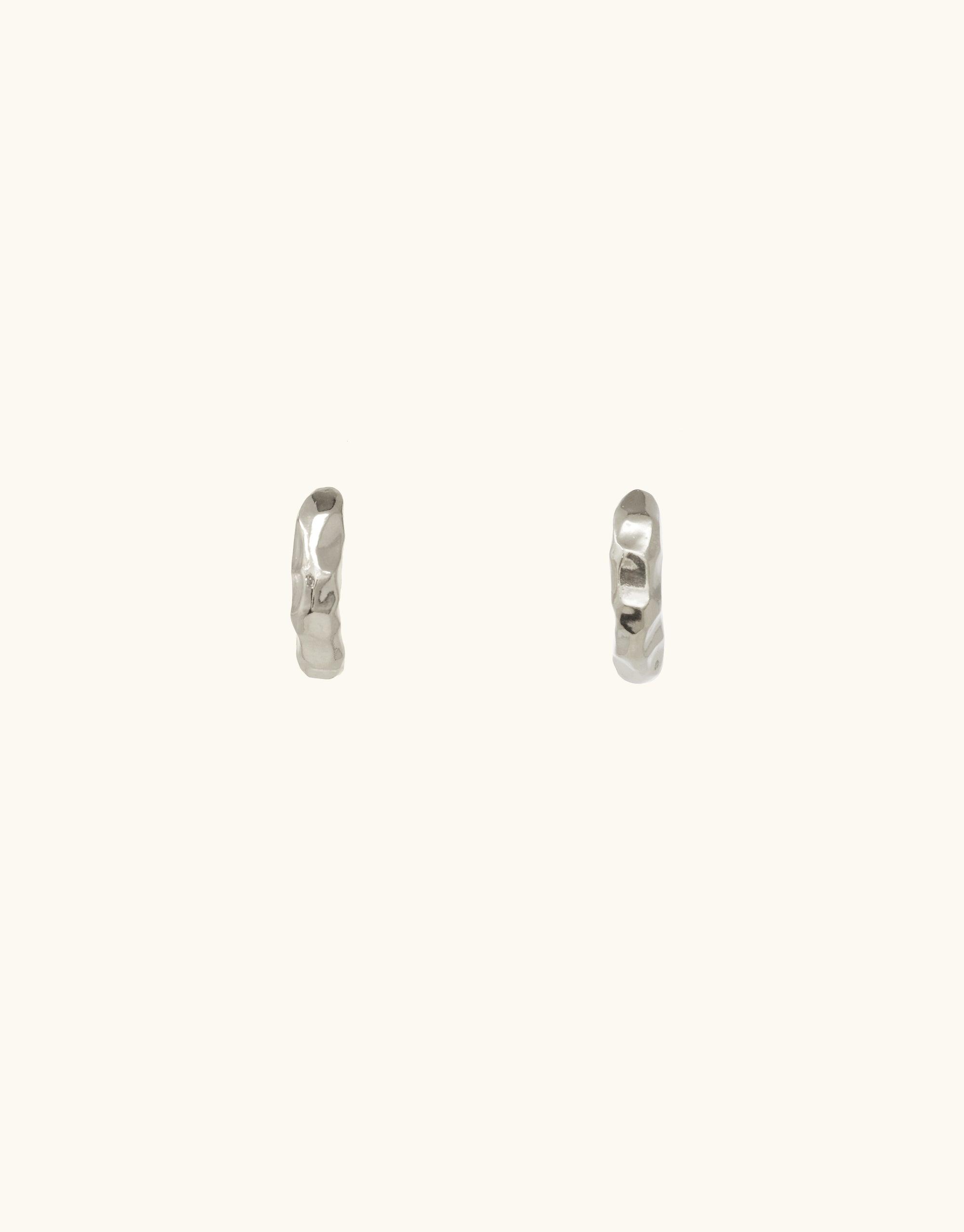 Elegant Rock Stud Earrings featuring textured, curved design inspired by canyon terrain. Handcrafted in sterling silver or gold vermeil, these versatile studs add a touch of abstract beauty to any outfit. Perfect for day-to-night wear. Handmade in Los Angeles by CLED.
