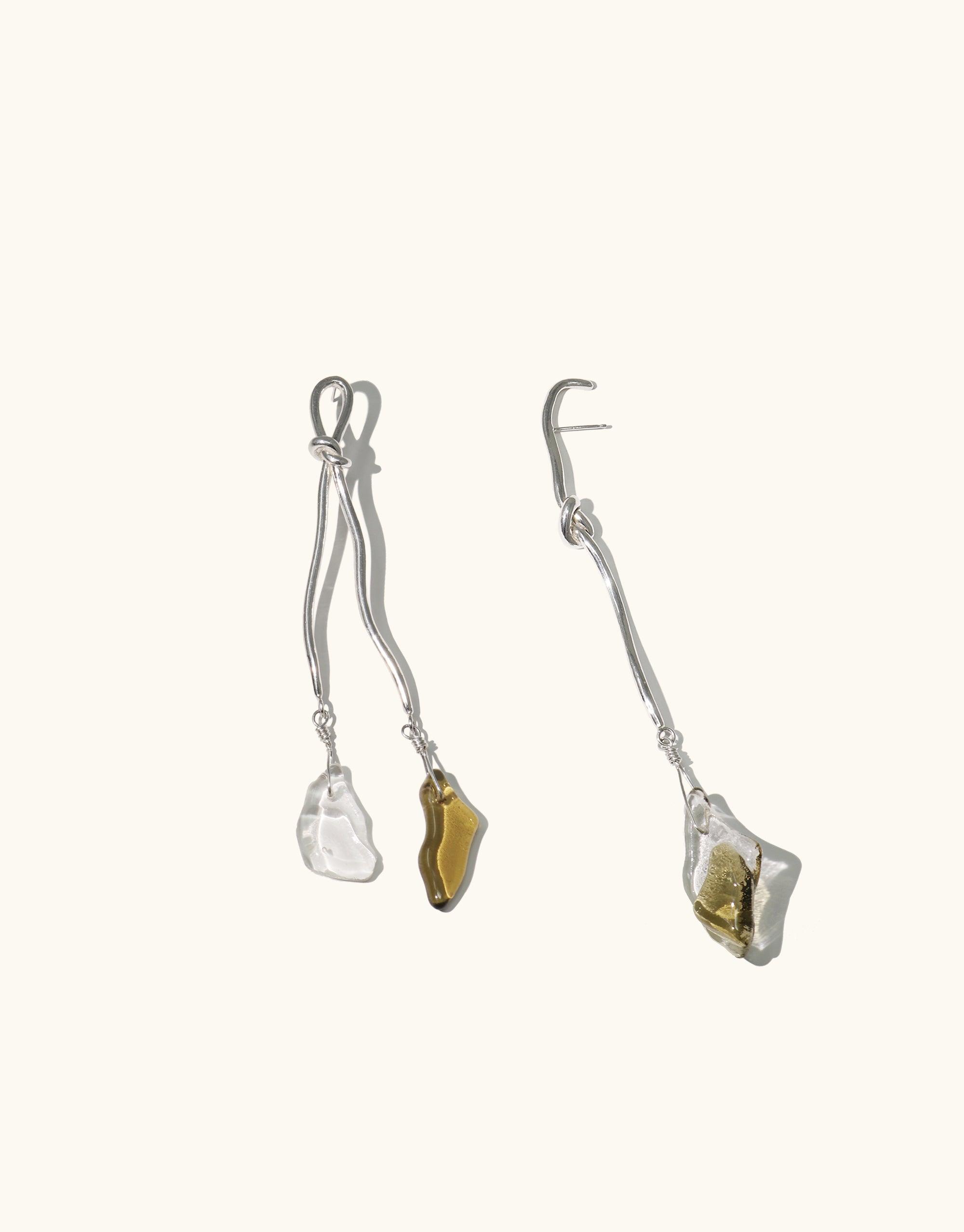 Rope Drop Earrings featuring abstract metal shapes inspired by climbing tools, paired with eco-friendly glass drops in clear and amber tones. Handcrafted asymmetrical design showcasing canyon-inspired forms. Sustainably made jewelry by CLED.