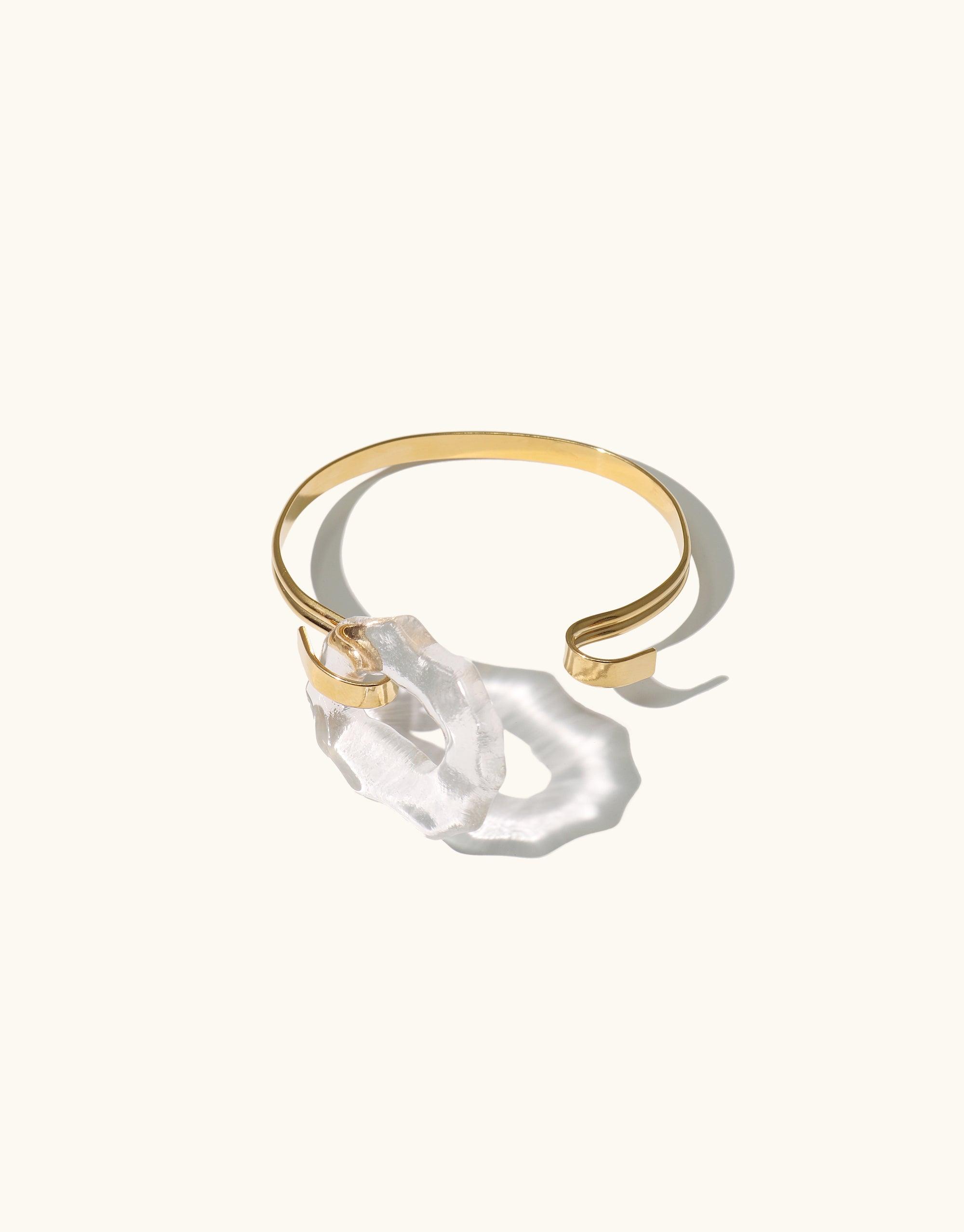 Gold vermeil Canyon Hook Bracelet featuring an organic oval shape with double bands and a handcrafted Eco Gem made from repurposed glass, showcasing abstract molten forms inspired by canyon terrain. Elegant and versatile design for everyday or dressy wear. CLED Canyon Hook Bracelet