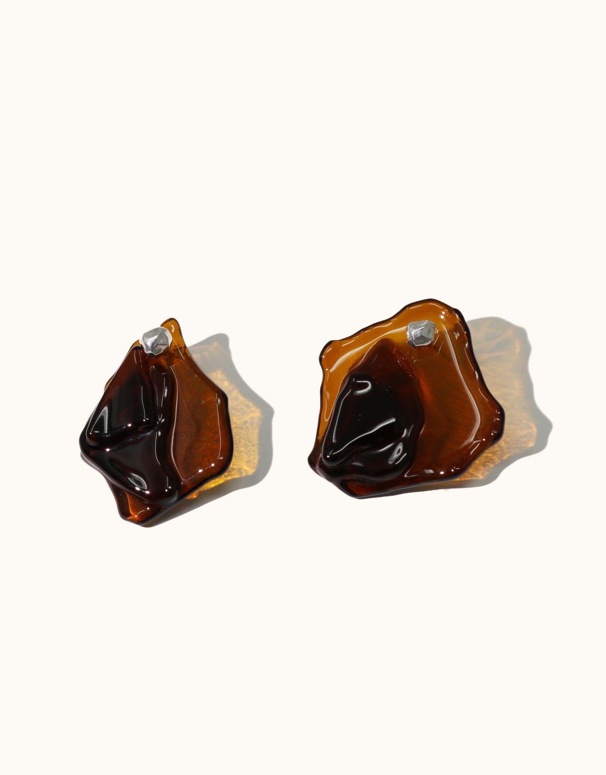 Plateau Earrings featuring abstract amber-colored glass shapes resembling canyon terrain. Handcrafted eco-friendly jewelry with layered, molten forms inspired by natural landscapes. Sustainable and unique accessories from the Terrain Collection by CLED.