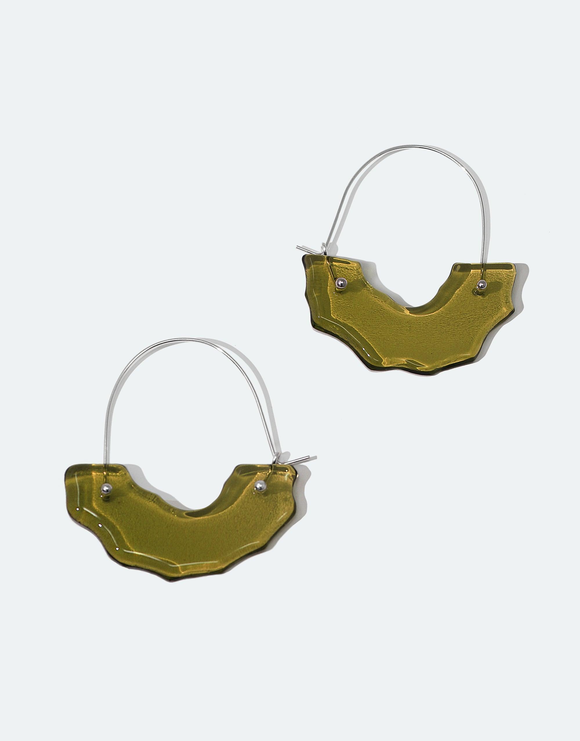 Polar Arch Hoop Earrings featuring abstract olive-green glass shapes suspended from silver hoops, inspired by arch-shaped icebergs. Handcrafted eco-friendly jewelry made from repurposed glass bottles. Climate change awareness design from the Floating Glacier Collection by CLED.