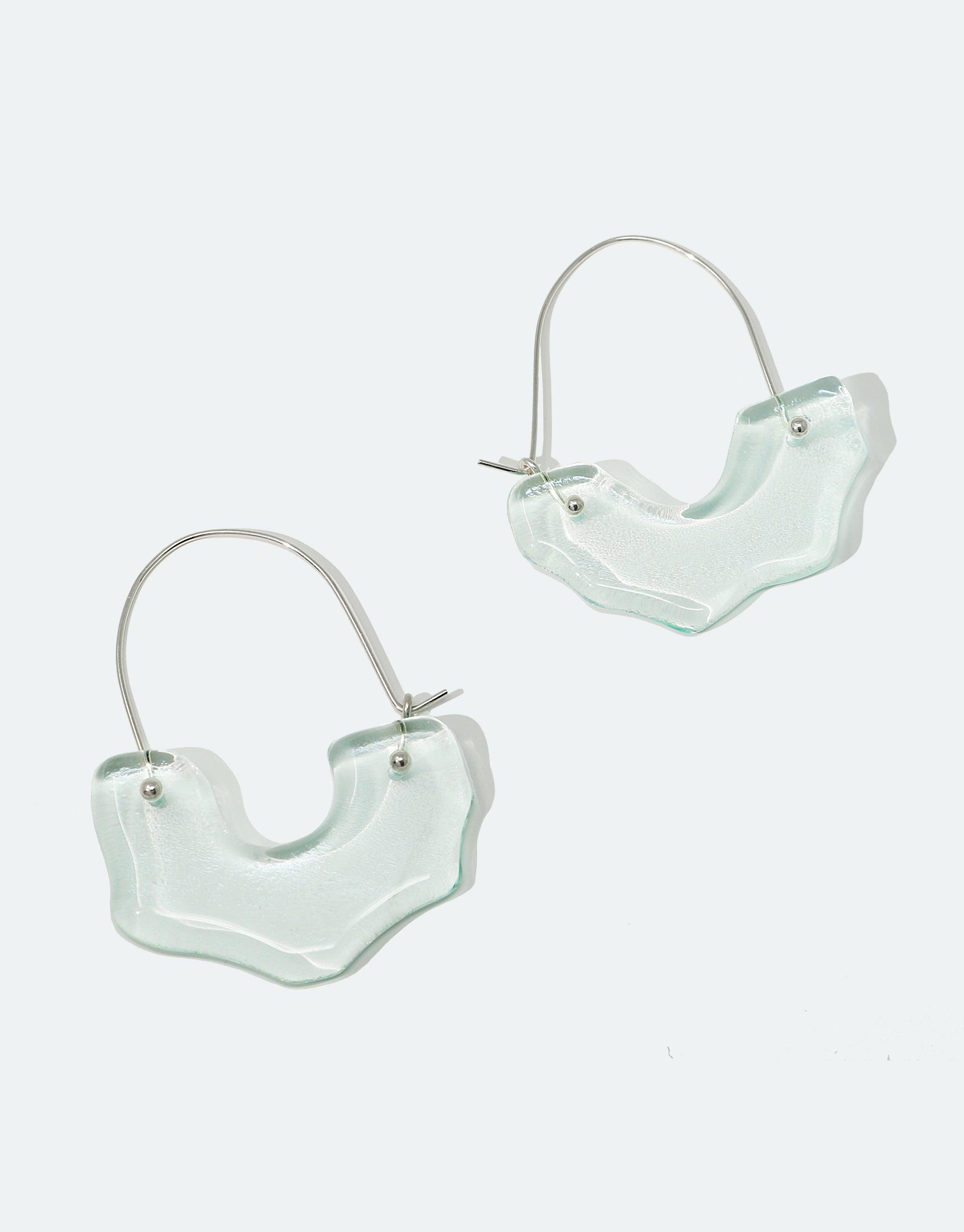 Polar Arch Hoop Earrings featuring abstract iceberg-shaped Eco Gem pendants made from repurposed glass bottles, suspended on silver hoops. Handcrafted sustainable jewelry inspired by Arctic landscapes, raising climate change awareness. CLED