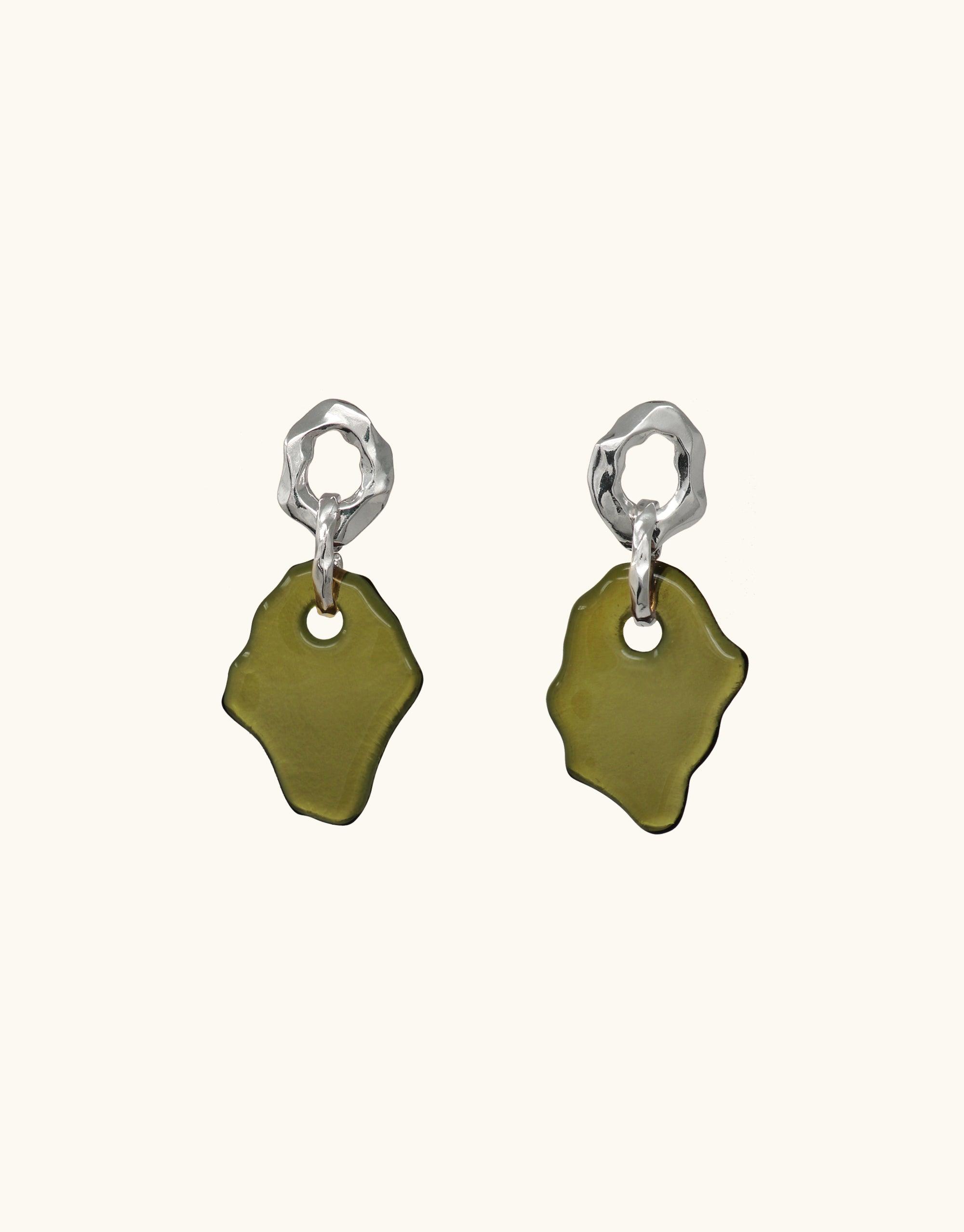 Handcrafted Canyon Earrings featuring organic silver shapes and olive green eco-glass pendants, inspired by canyon terrain. Unique, sustainable jewelry design showcasing abstract molten forms and layered textures. Elegant and eco-friendly accessories by CLED.