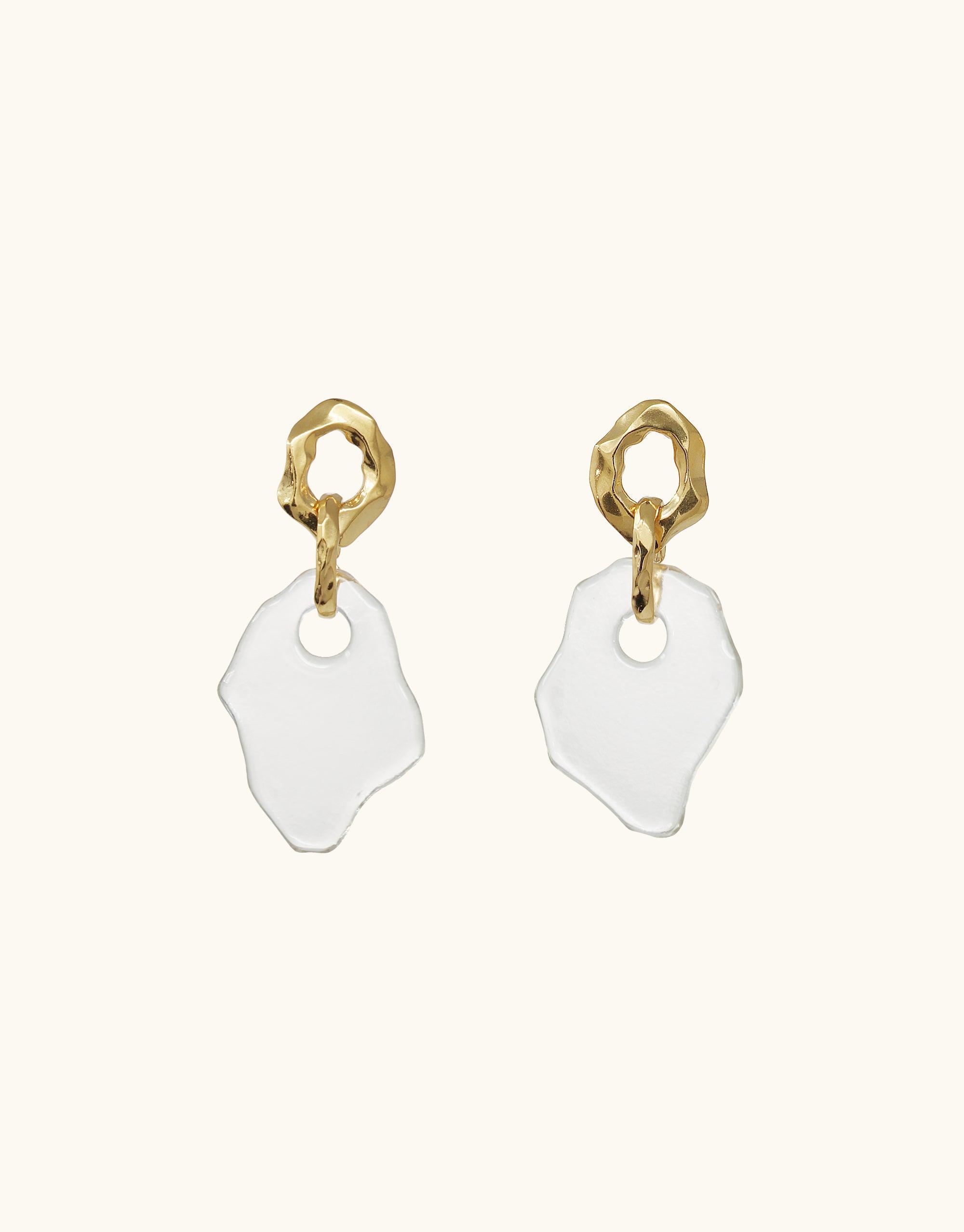 Gold vermeil earrings with organic-shaped white glass pendants, inspired by canyon terrain. Handcrafted design featuring twisted metal studs and irregular glass drops. Eco-friendly jewelry from the Terrain Collection. Canyon Earrings by CLED.