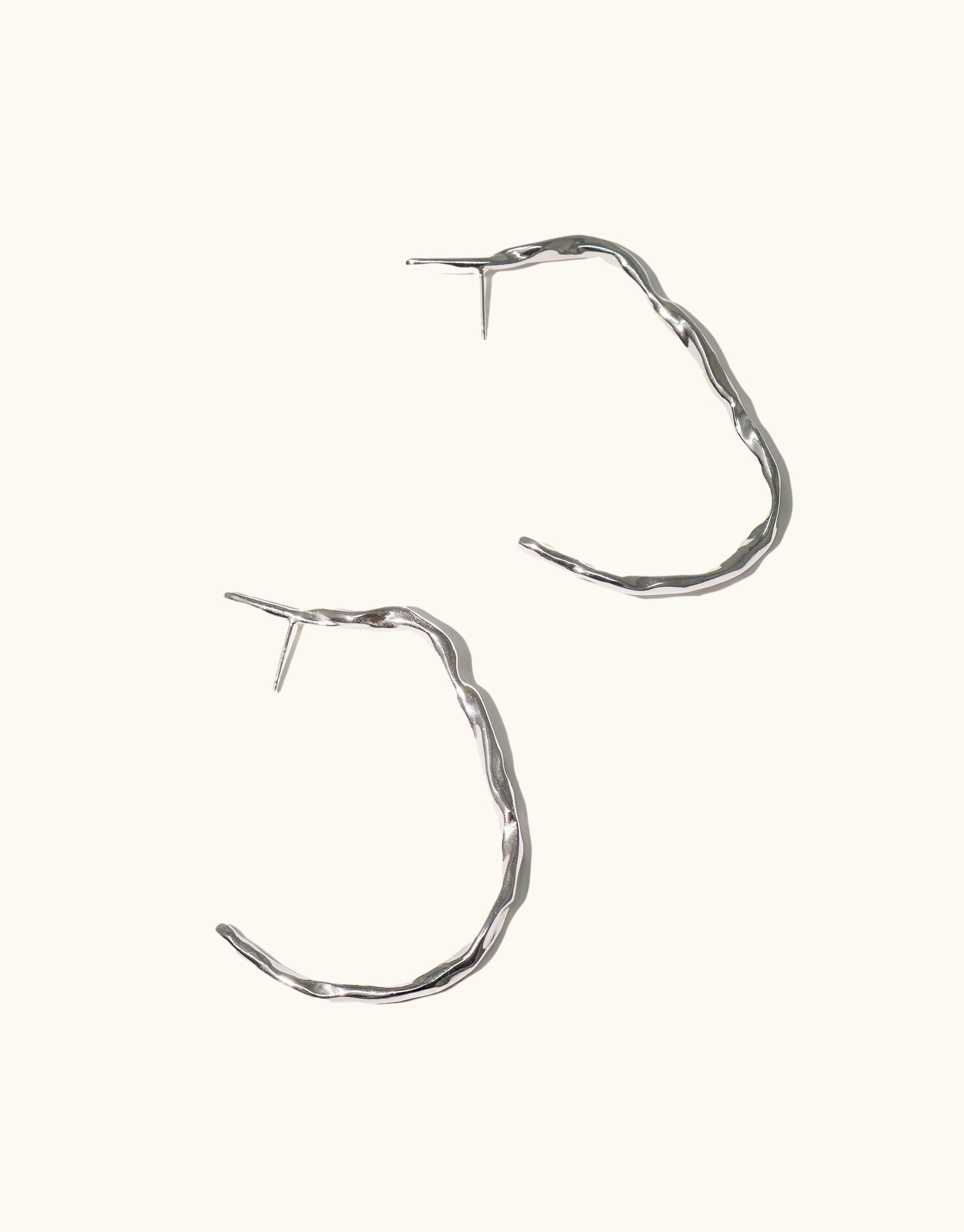 Vale Hoop Earrings featuring open back hoops with curved lines, inspired by canyon valleys, crafted in sterling silver, 2.4 inches long. Part of CLED's eco-conscious Terrain Collection.
