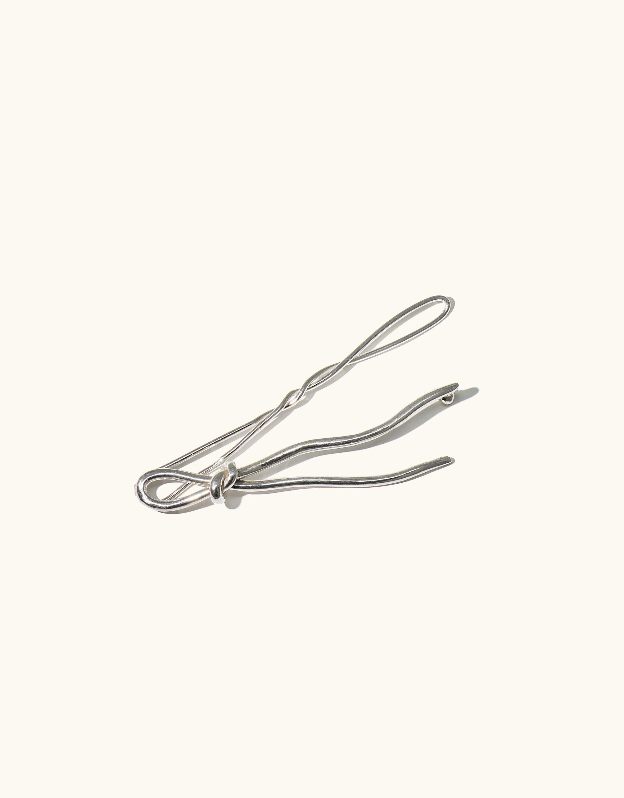 Elegant Double Rope Hair Barrette in silver metal, featuring a twisted design inspired by canyon terrain. Handcrafted accessory with abstract molten forms, 3 inches long. Adds a sophisticated touch to any hairstyle. Part of the Terrain Collection by CLED. Double Rope Hair Barrette.