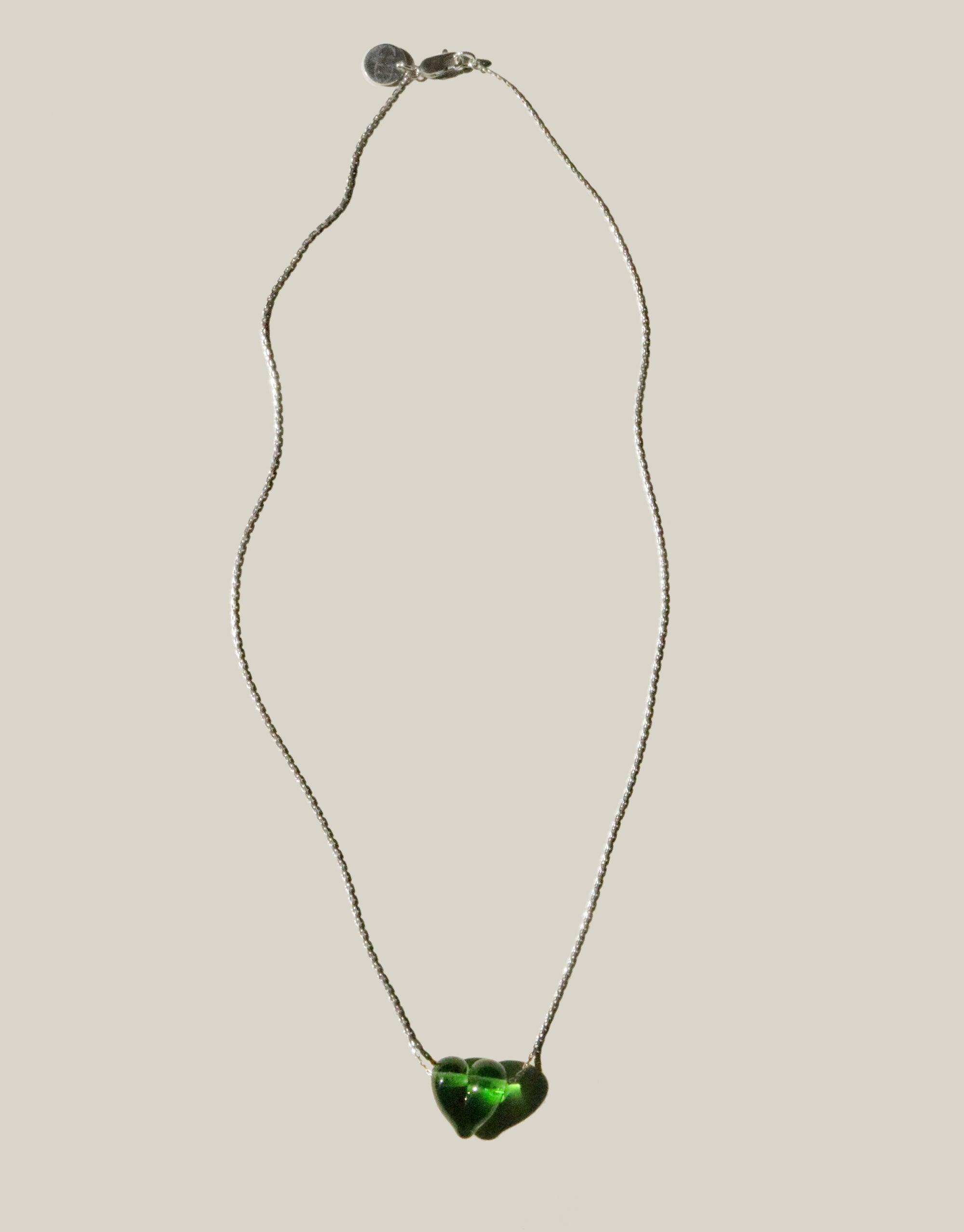 Elegant Love Necklace featuring a handcrafted green glass heart pendant on a delicate sterling silver chain. Sustainable jewelry piece made from repurposed glass, showcasing CLED's commitment to eco-friendly design. Love Necklace by CLED.