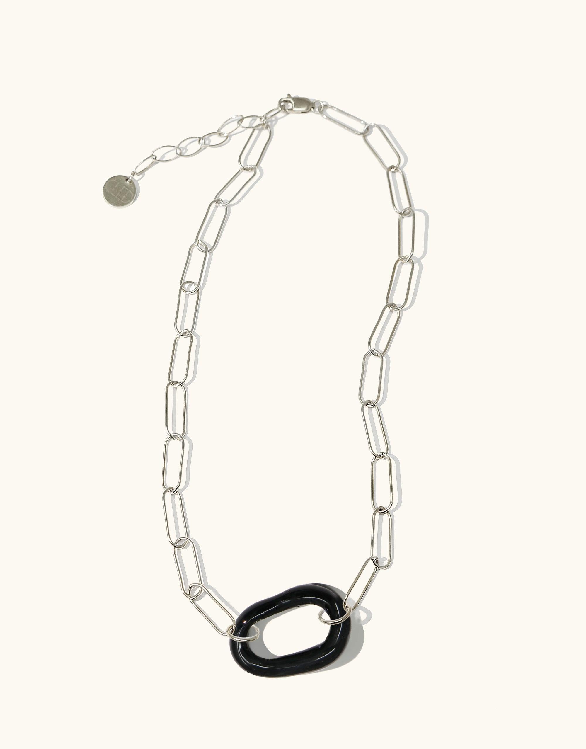 The Day Loop Necklace with a black oval Eco Gem pendant on a long silver chain, showcasing CLED's eco-conscious design handcrafted in Los Angeles from repurposed glass.