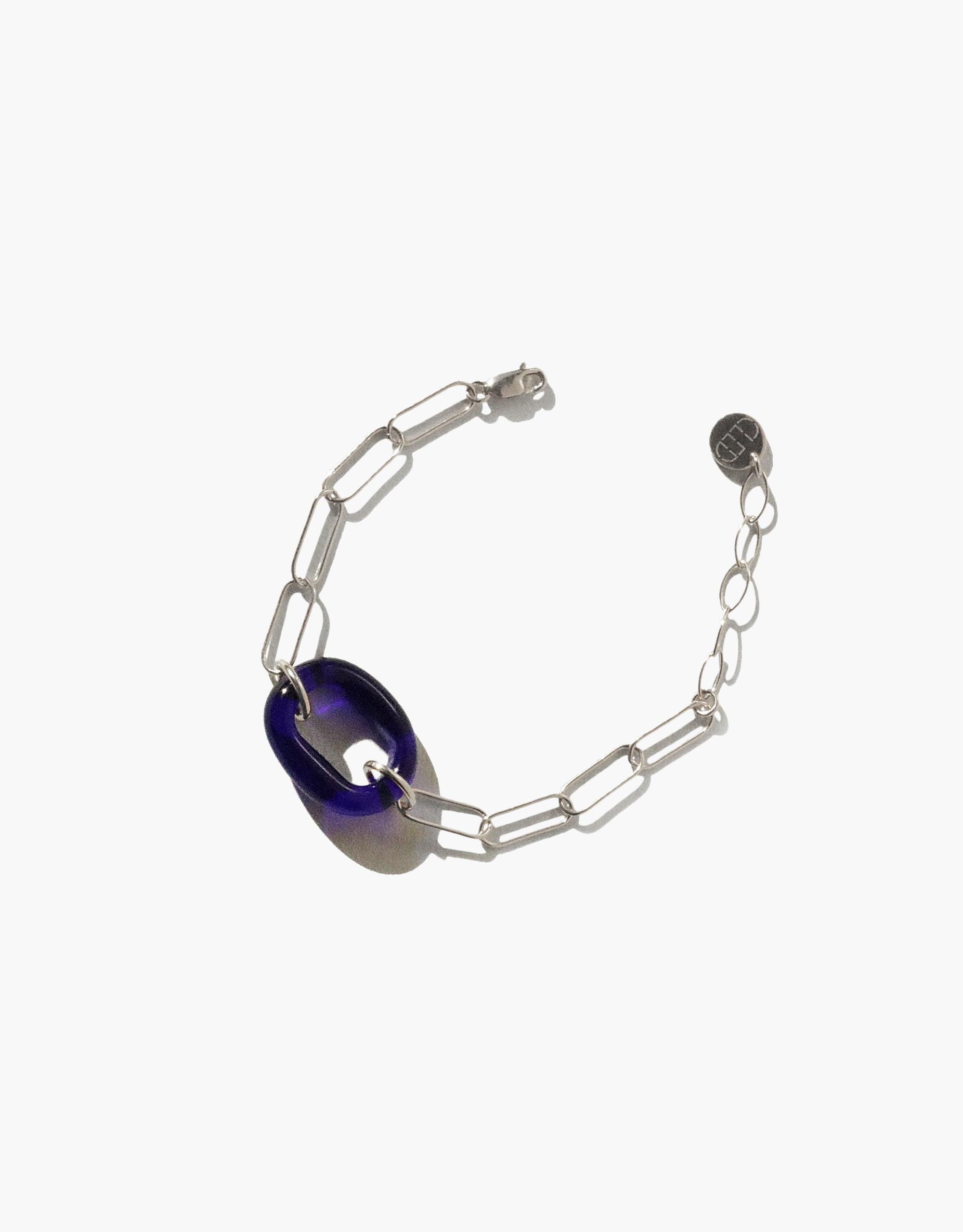 The Day Loop Bracelet features a blue Eco Gem bead on a sterling silver chain, showcasing CLED's eco-conscious craftsmanship in transforming recycled glass into minimalist jewelry.