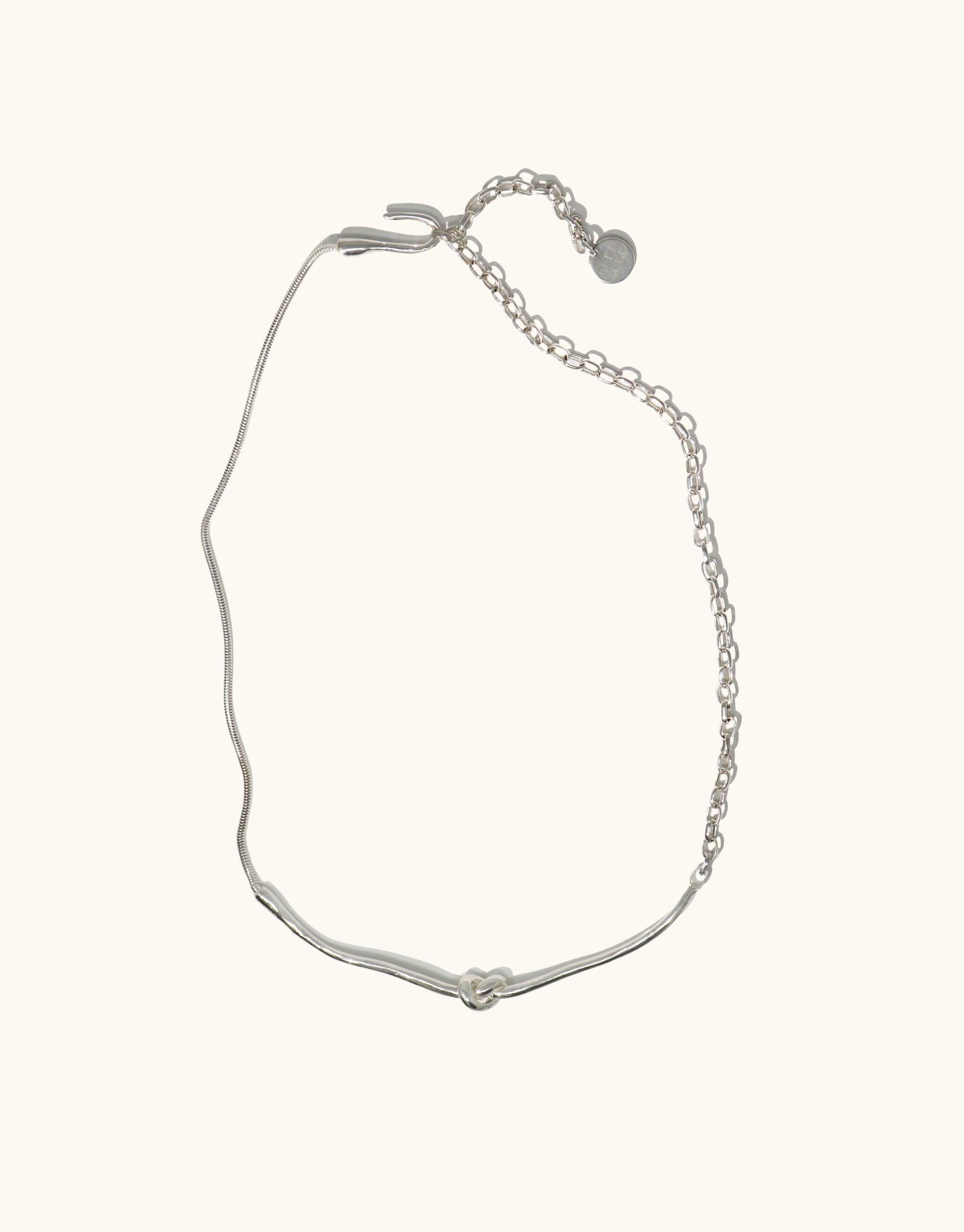 Elegant silver Rope Hook Necklace with abstract molten form inspired by canyon terrain, featuring adjustable chain and hook closure. Versatile design for front or back wear. Handcrafted piece from the Terrain Collection by CLED.