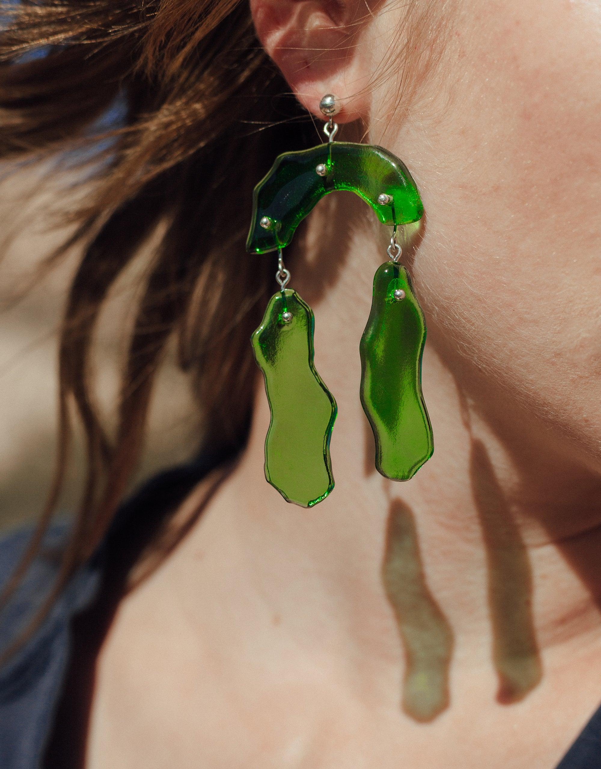 Eco-friendly Rock Dangling Earrings featuring green glass charms in abstract shapes, inspired by canyon terrain. Handmade design with unique curves and layers, showcasing sustainable artistry. Elegant statement piece for nature-inspired fashion. CLED Rock Dangling Earrings.
