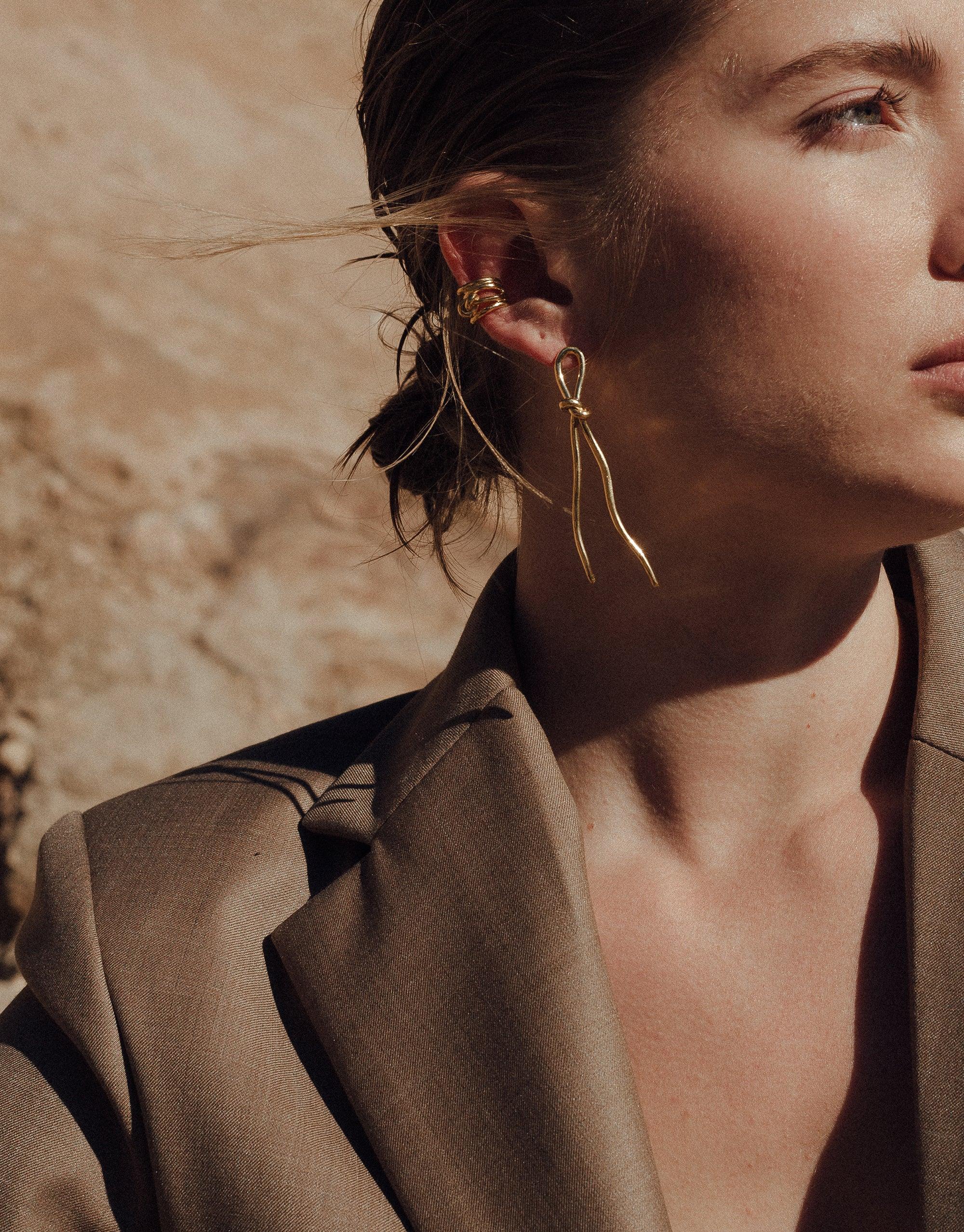 Gold Rope Earrings from Terrain Collection, inspired by canyon formations. Elegant, elongated design mimicking climbing ropes. Handcrafted in Los Angeles, available in sterling silver or gold vermeil. Versatile and stylish accessory for any outfit. Rope Earrings by CLED.