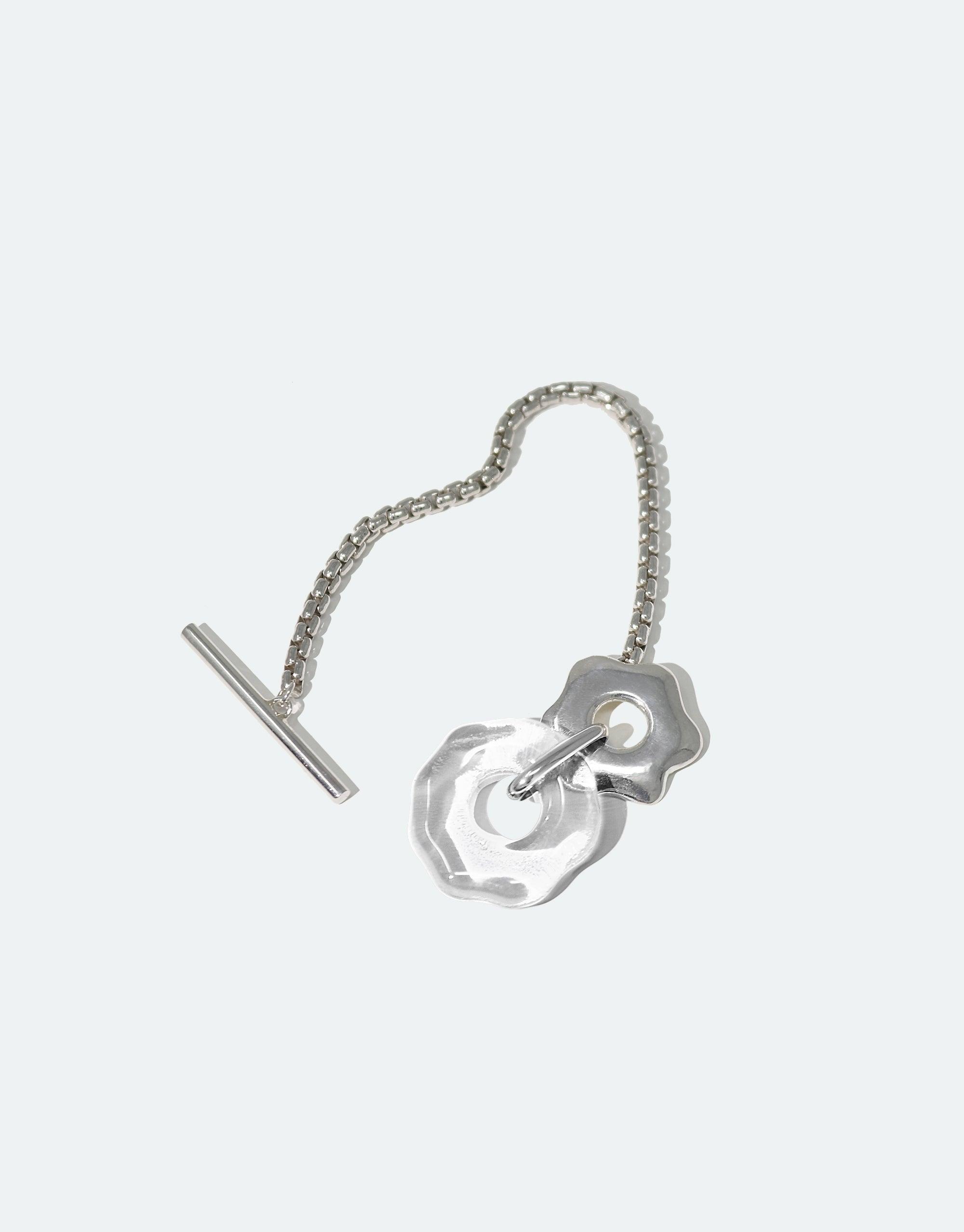 Avens Toggle Bracelet featuring a silver chain with flower-inspired pendant and toggle closure, showcasing eco-friendly design with repurposed glass charm, part of the Floating Glacier Collection by CLED