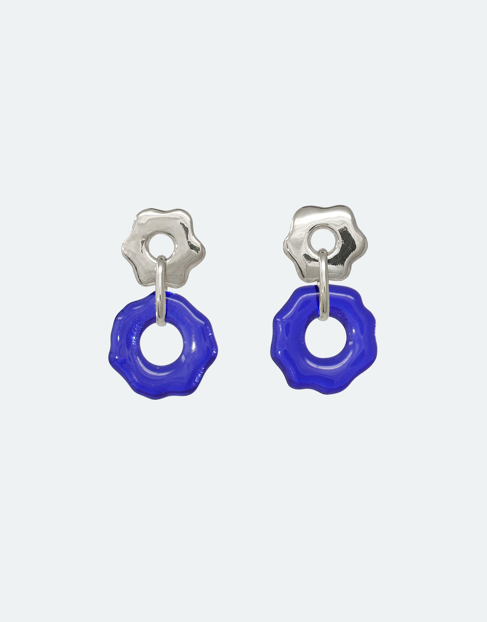 Avens Earrings featuring silver flower-shaped studs with vibrant blue glass pendants, showcasing eco-friendly design inspired by Arctic flora. Handcrafted earrings representing climate change awareness and sustainable fashion. CLED, Avens Earrings