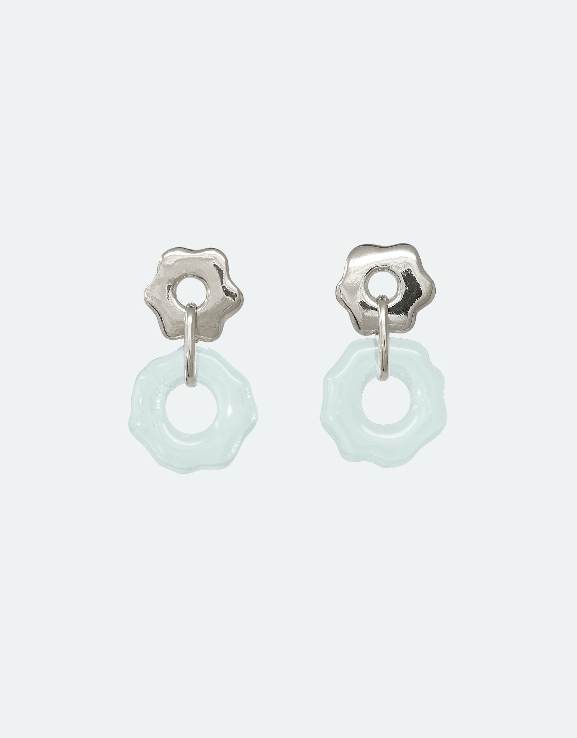 Avens Earrings featuring delicate flower-shaped silver studs with translucent light blue circular pendants made from eco-friendly repurposed glass, showcasing sustainable jewelry design inspired by Arctic flora and climate awareness CLED
