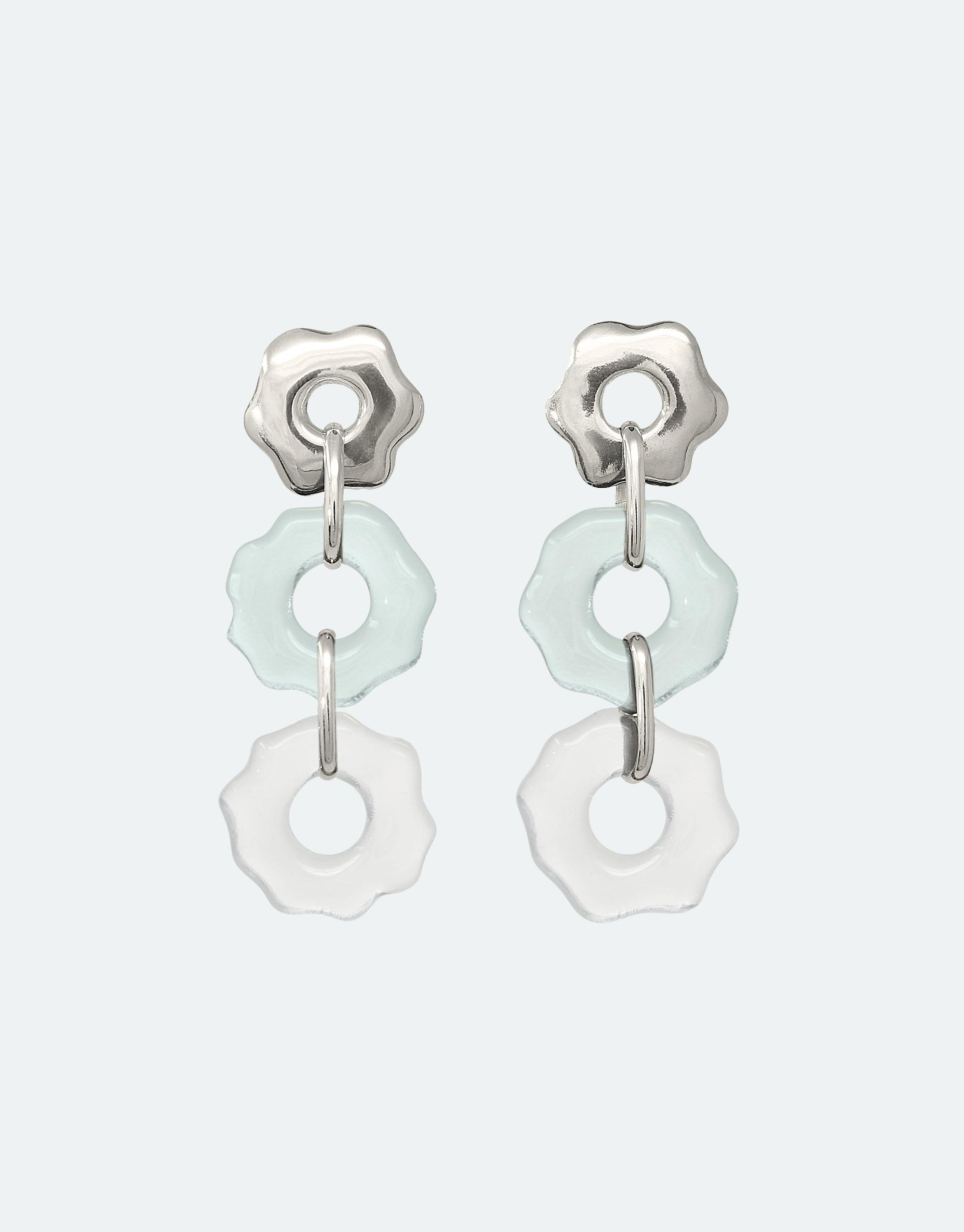 Avens Earrings Trio featuring three organic floral charms in silver and eco-friendly glass. Delicate, handmade earrings with light blue and clear dangling elements, inspired by floating glaciers. Sustainably crafted jewelry by CLED.