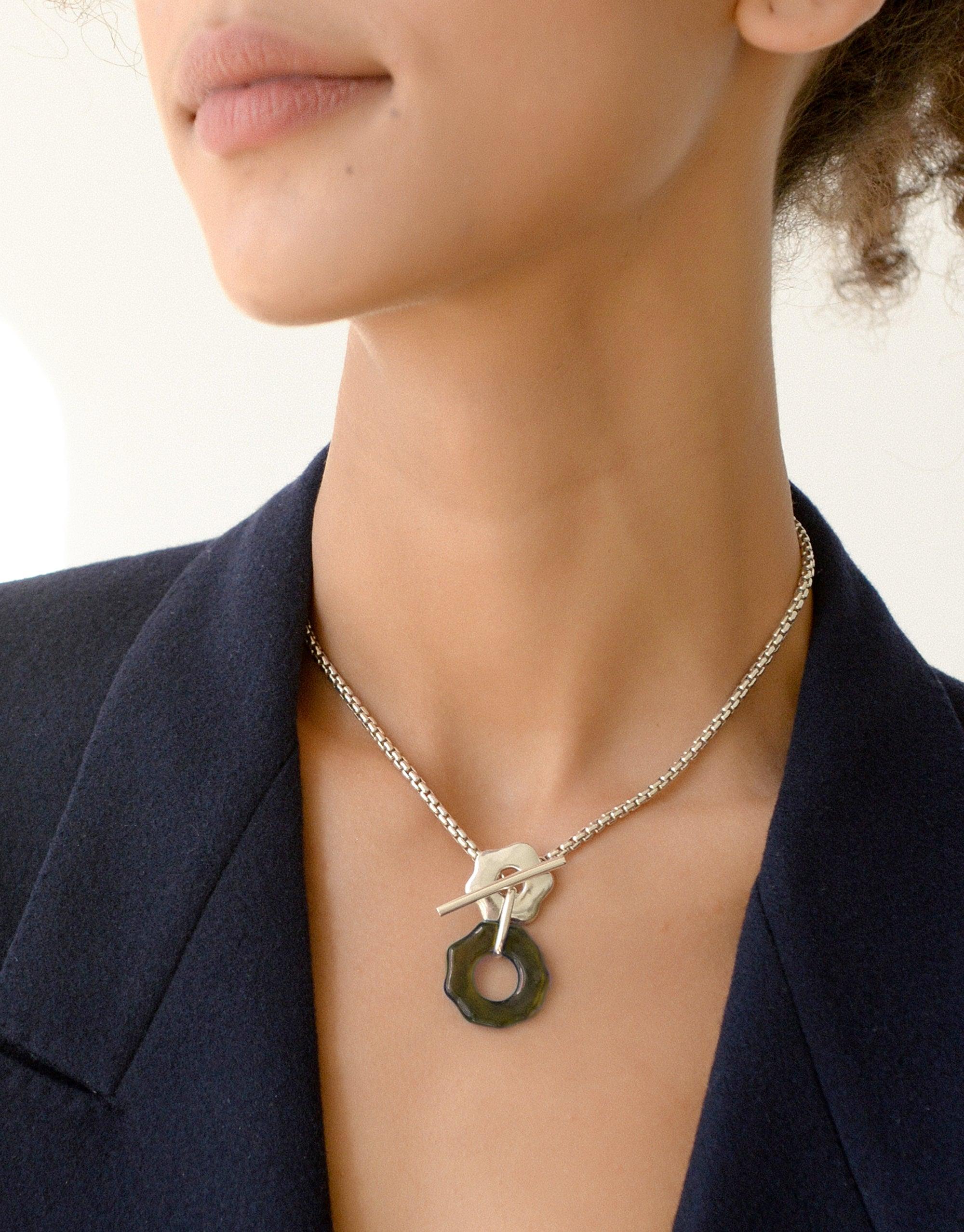 Elegant Avens Toggle Necklace with eco-friendly pendant, showcasing versatile front closure design. Delicate chain and abstract flower-inspired pendant highlight sustainable luxury. Part of the Floating Glacier Collection by CLED.