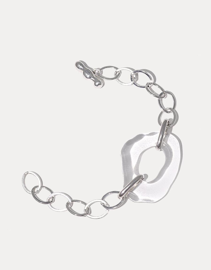 High Tide Oval Chain Bracelet featuring sterling silver links and a unique, hand-formed eco gem pendant made from repurposed glass. The bracelet showcases an organic free shape design, combining elegance with sustainability. CLED